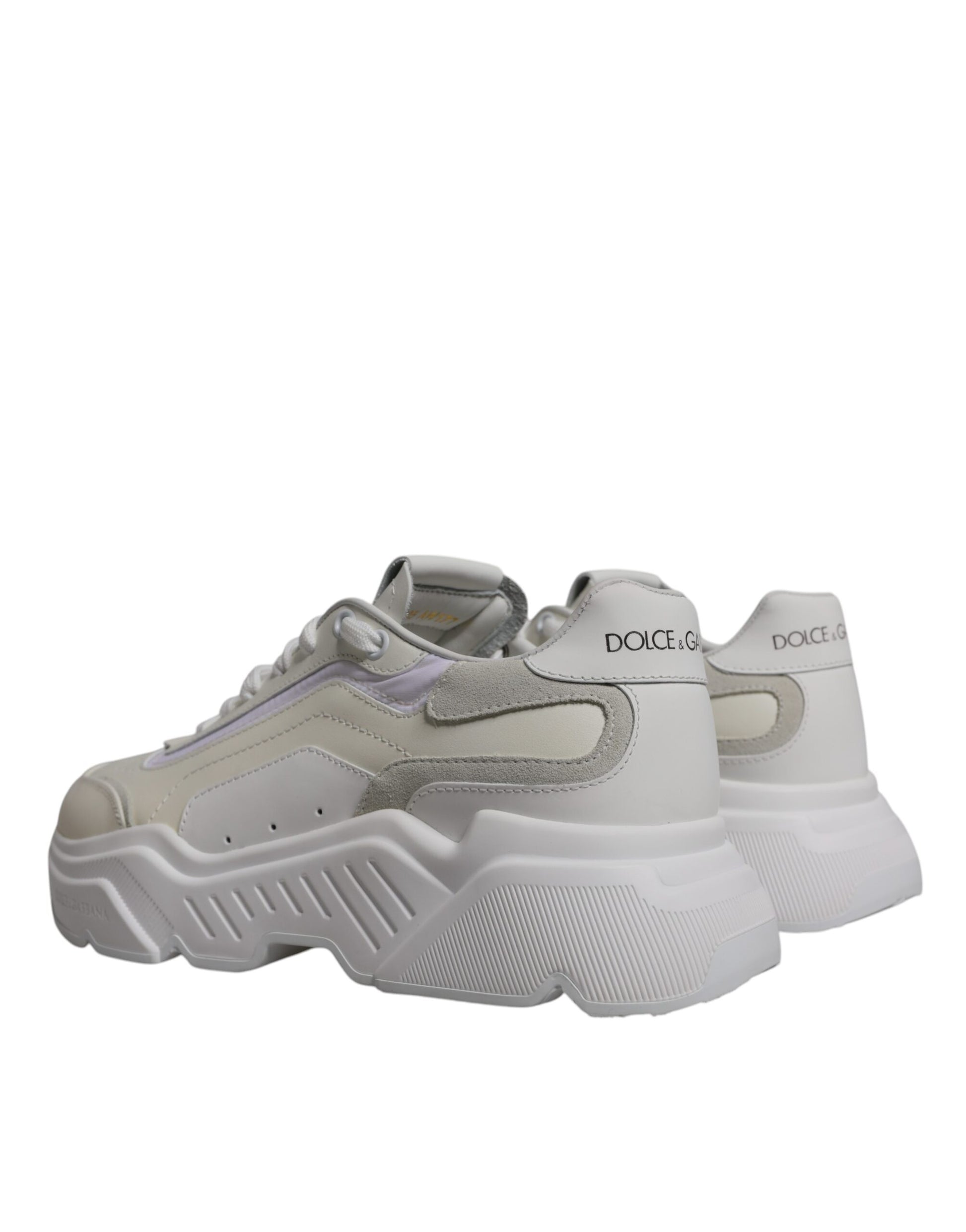 Pair of white sneakers with black laces, featuring a low top design and the Dolce & Gabbana logo on the side