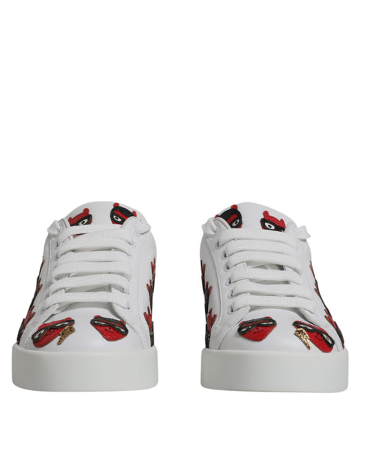 Pair of white sneakers with red lips print on side