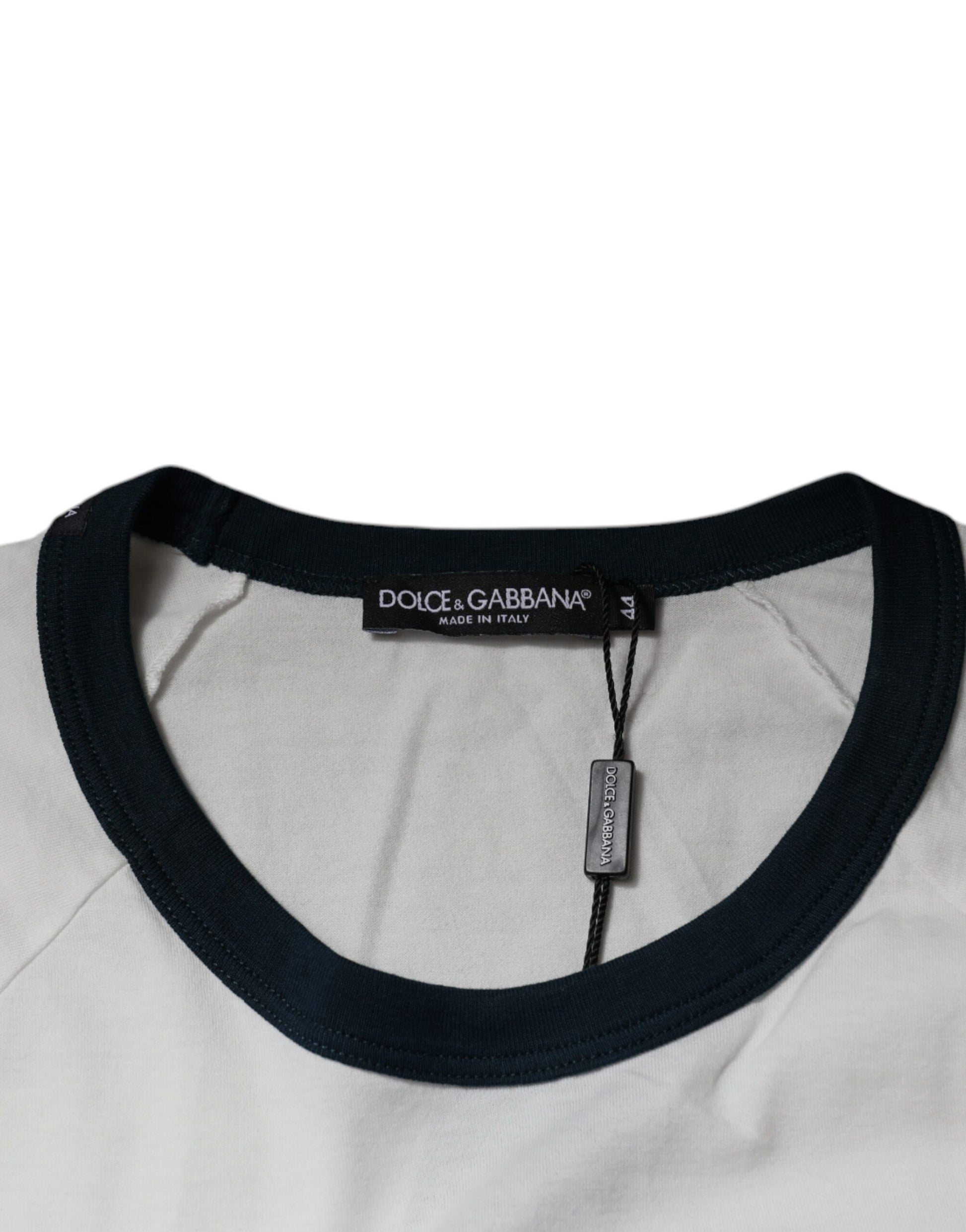 A sweater with a dark collar and cuffs