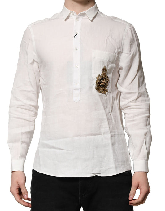 A long-sleeved white shirt with a gold crown embellishment on the left chest
