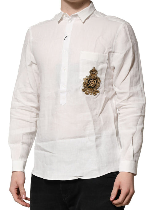 A long-sleeved white shirt with a gold crown embellishment on the left chest