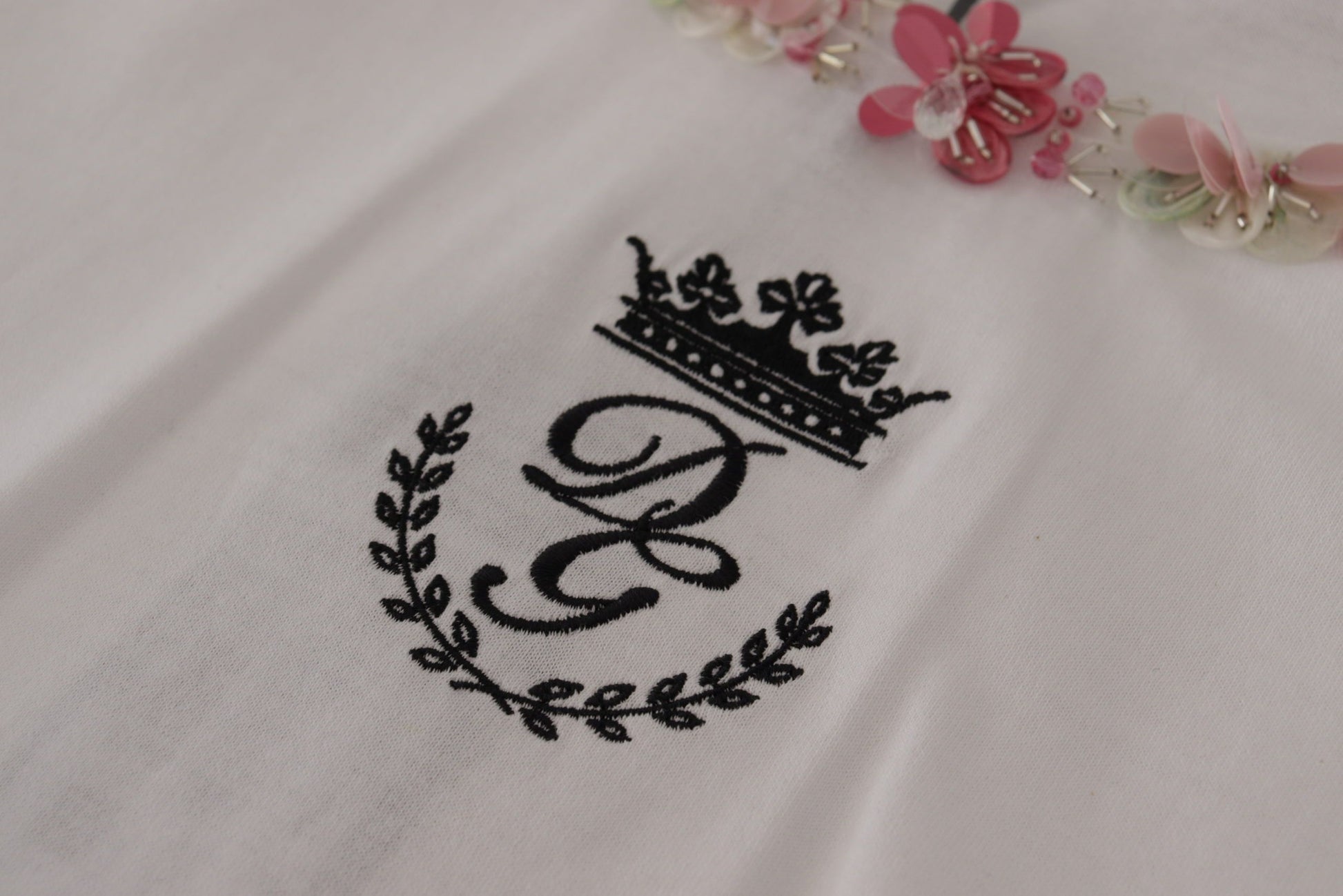 Embroidered emblem on white fabric