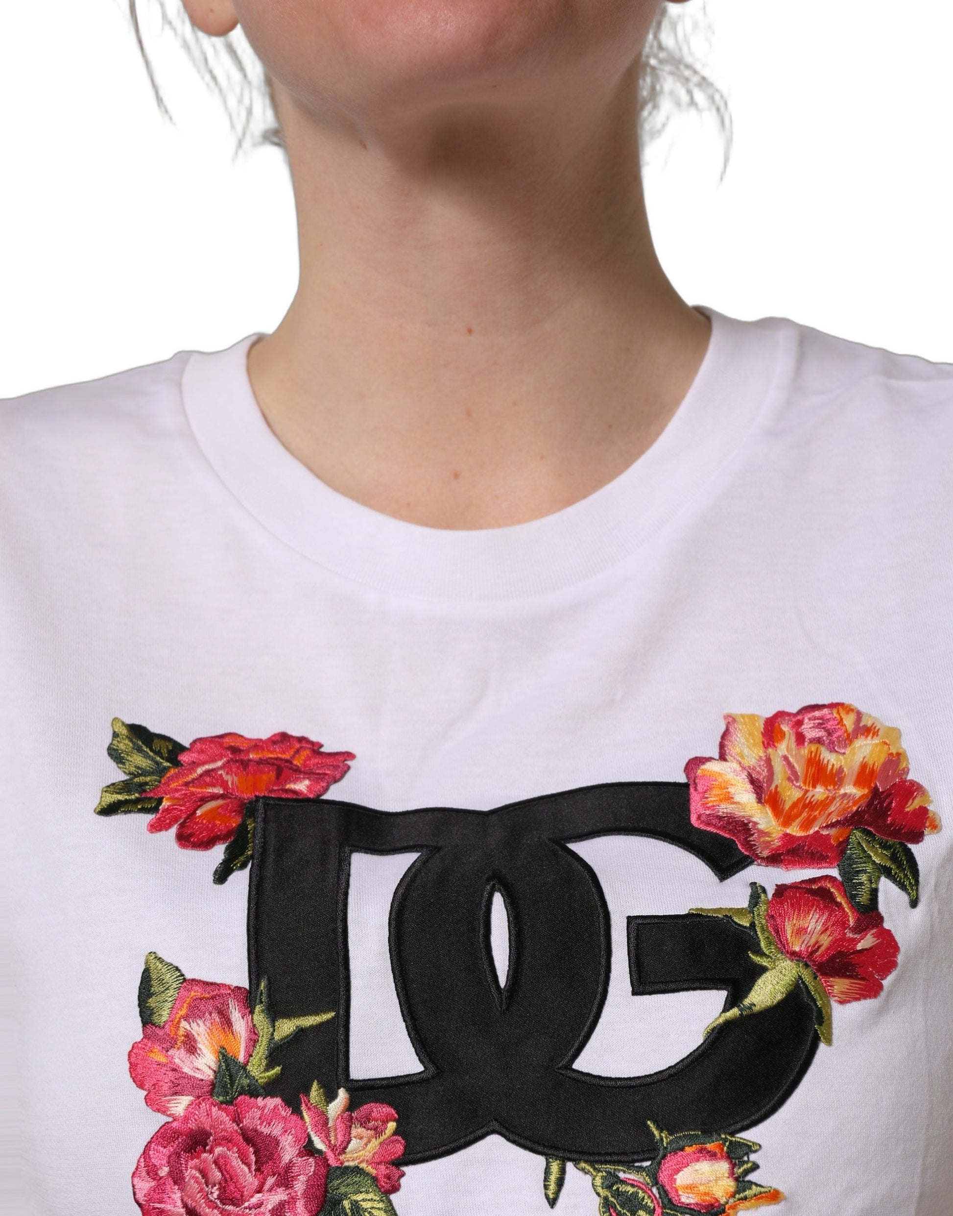 A white crop t-shirt with a floral design and the brand's logo