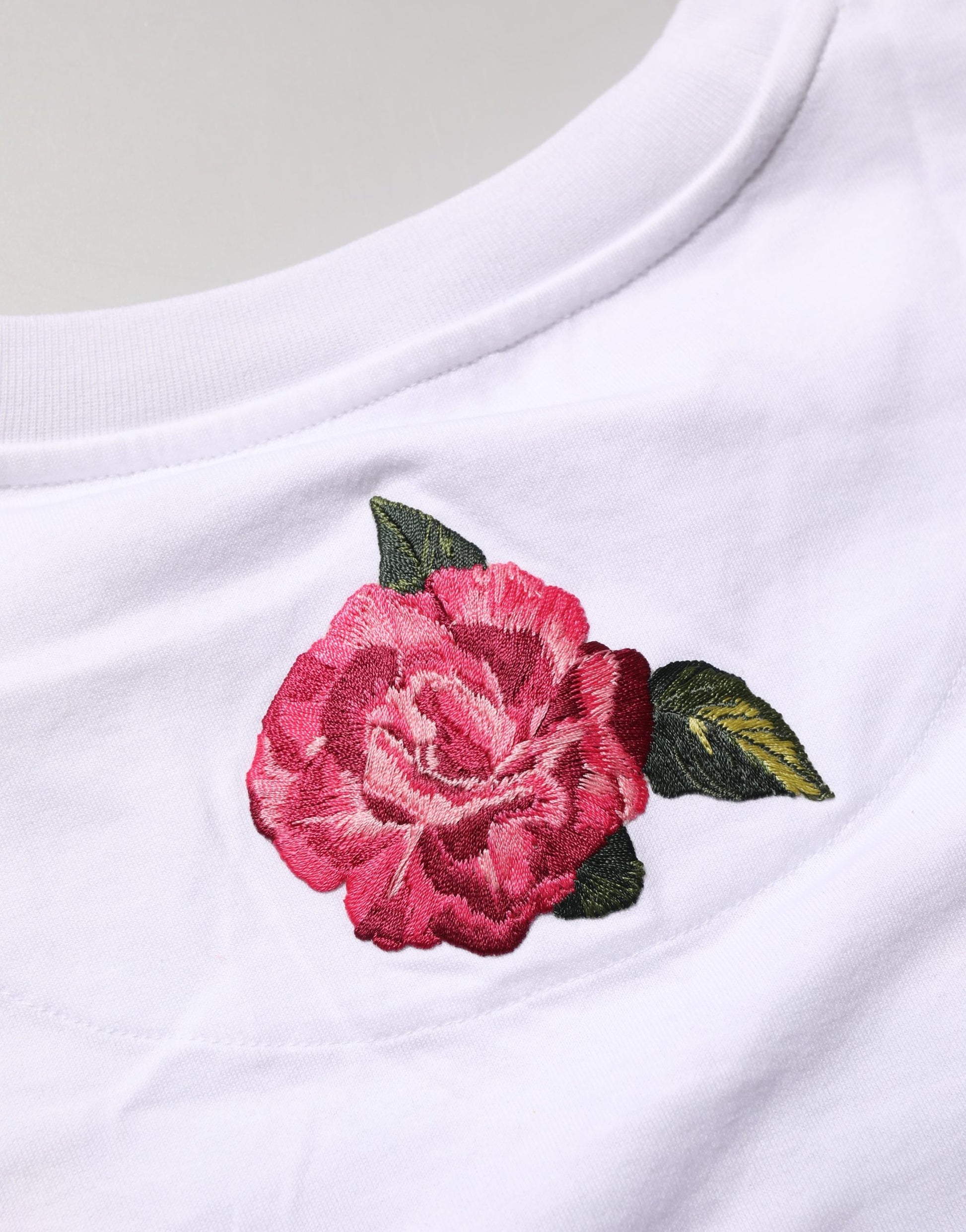 Pink rose embroidery on white t-shirt