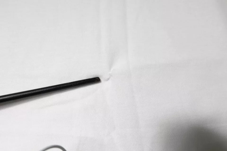 Black metal wire on white cloth