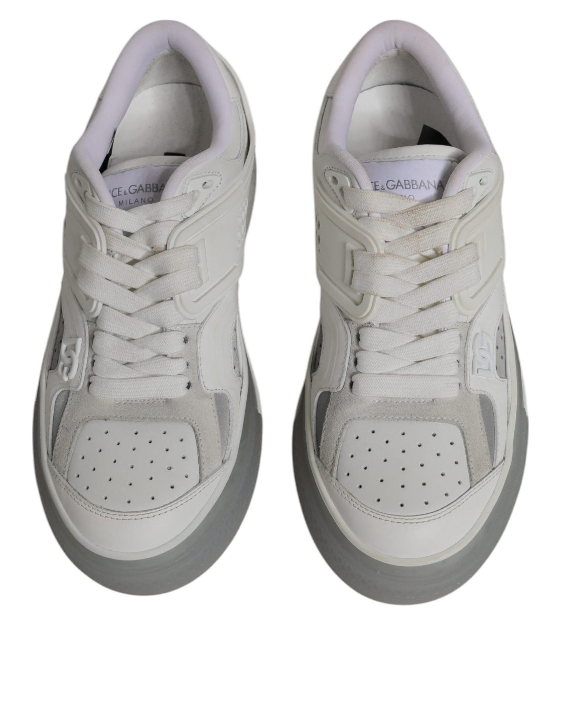 Pair of white sneakers with black laces and a small logo on the tongue