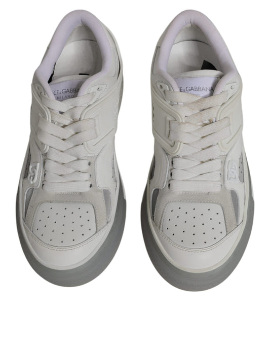 Pair of white sneakers with black laces and a small logo on the tongue