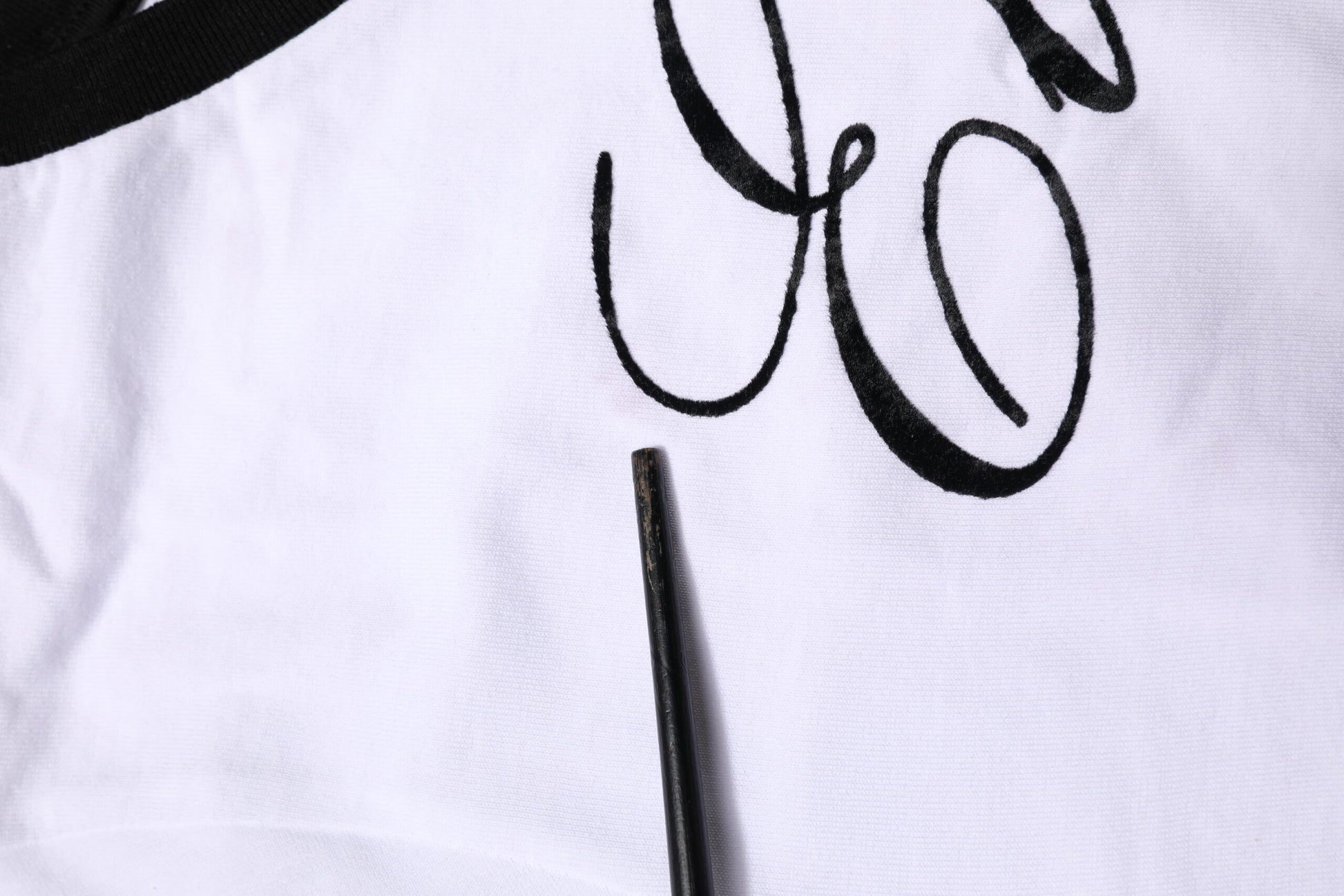 Black pen on white fabric