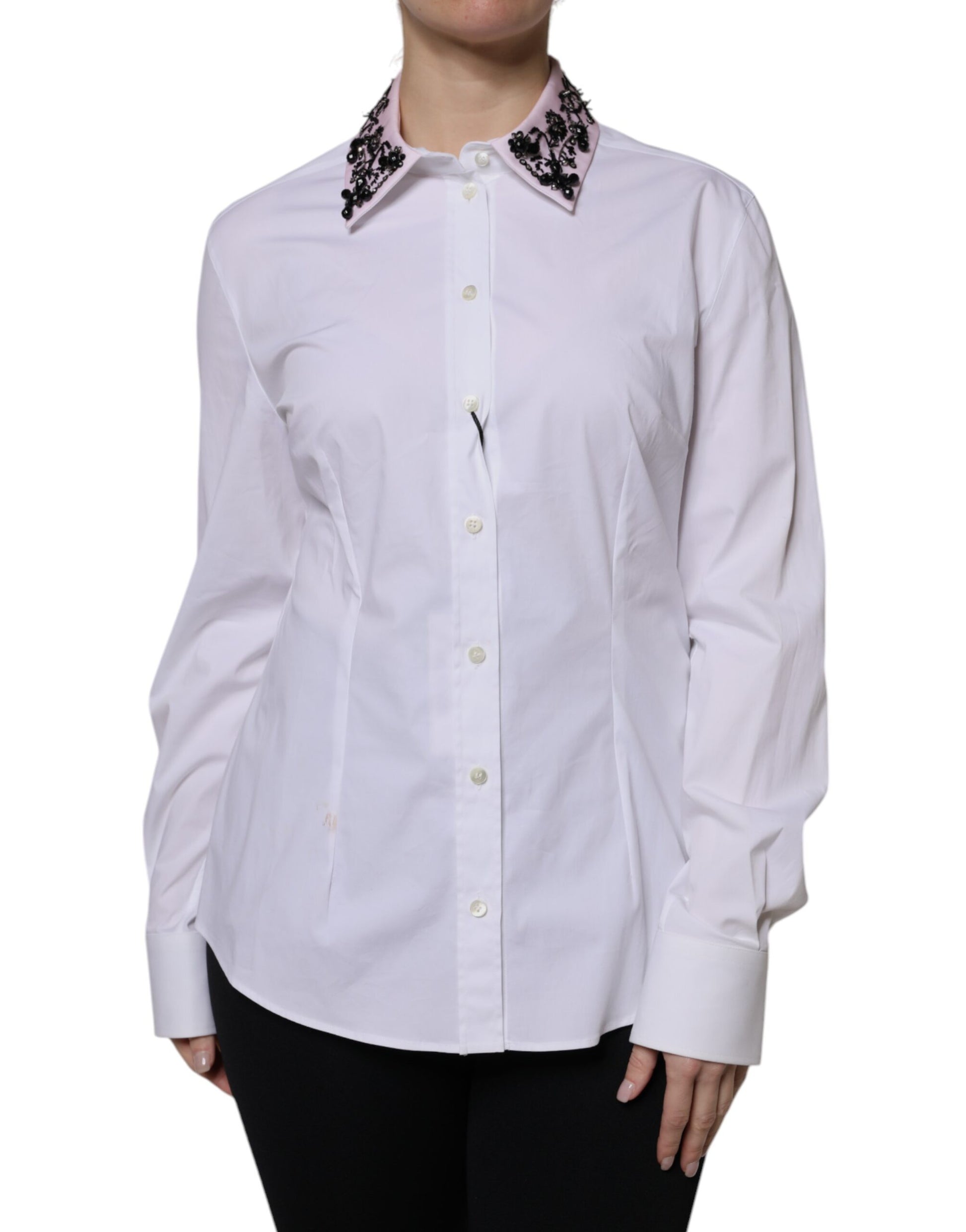 A white collared dress shirt with embellishments on the shoulders and sleeves