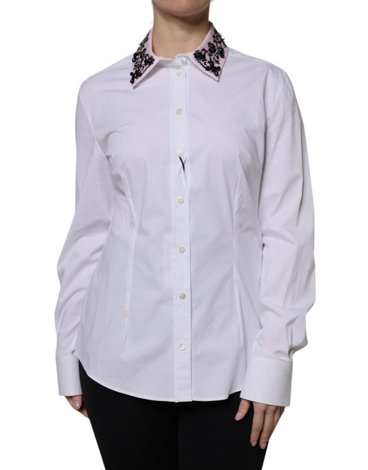 A white collared dress shirt with embellishments on the shoulders and sleeves