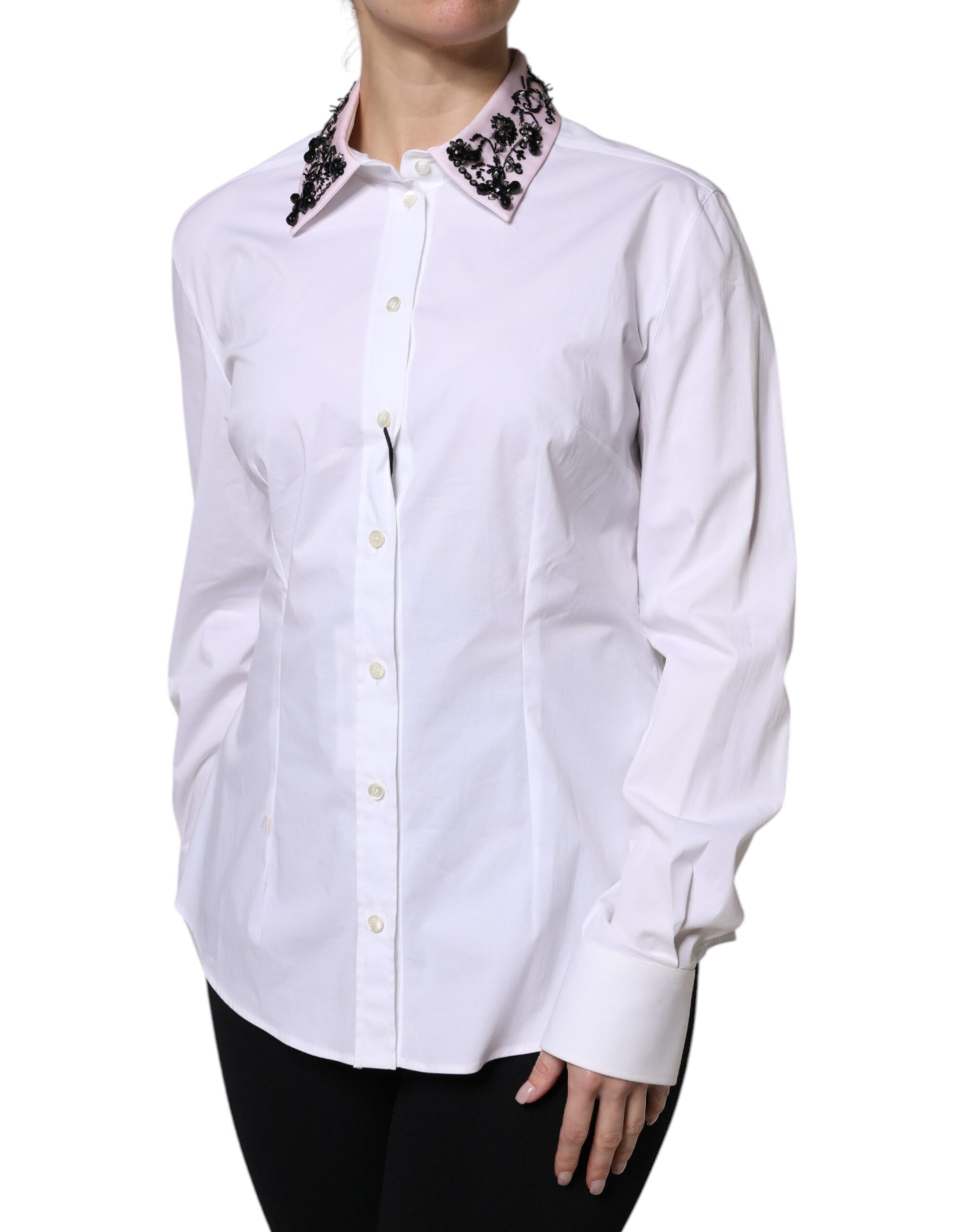 A white collared dress shirt with black lace detailing on the shoulders and sleeves