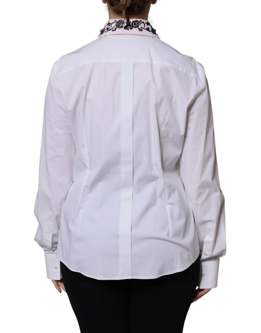 A white collared dress shirt with embellishments on the shoulders and sleeves