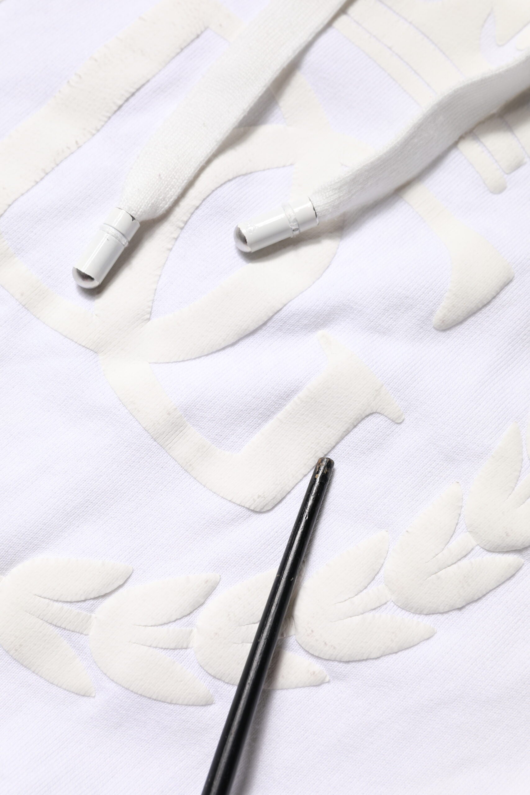 Black ink pen on white fabric