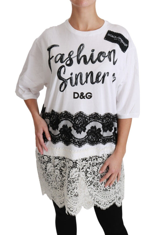 Woman wearing a white sweater with black lettering and a patterned skirt