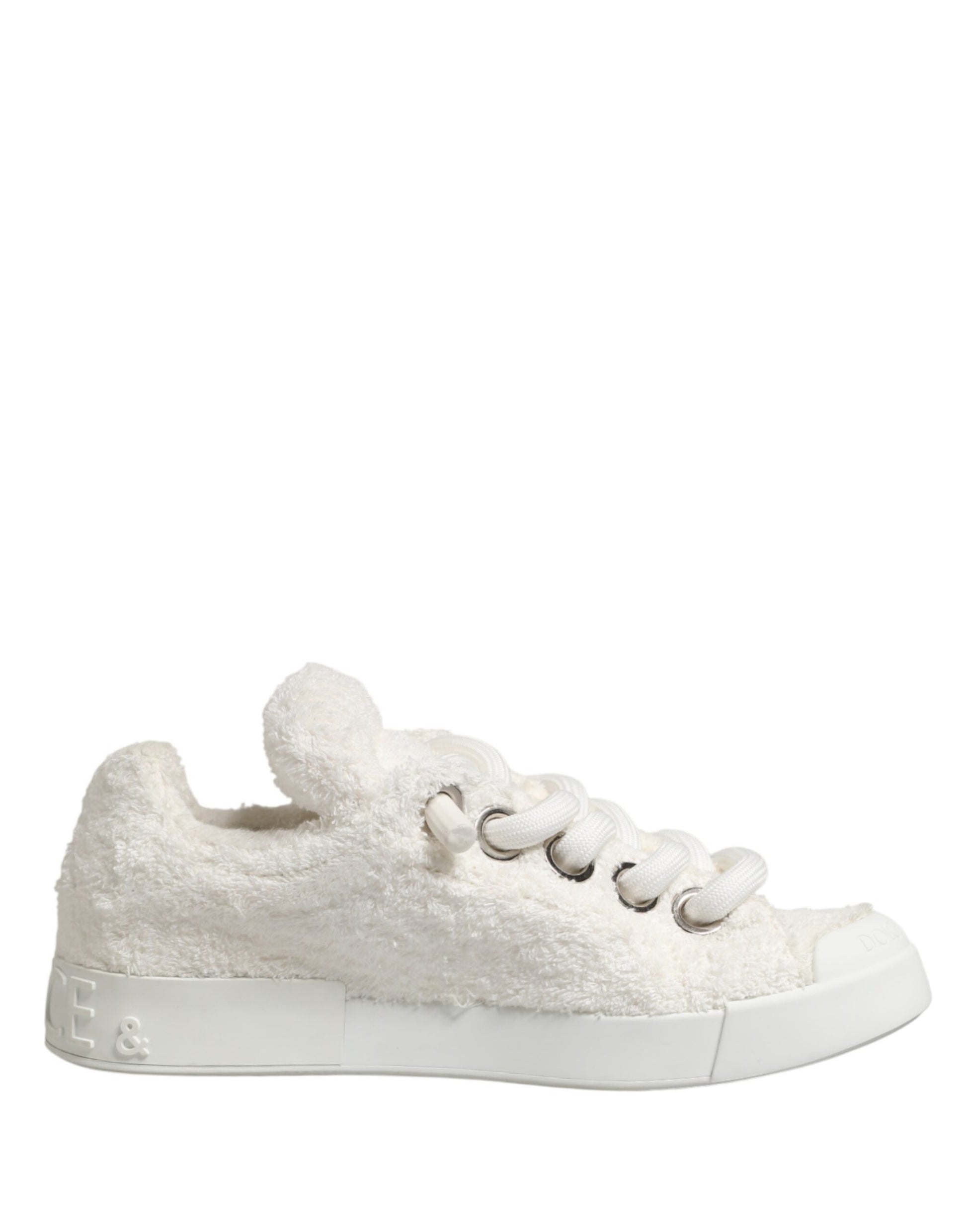 A pair of white faux shearling low top sneakers with a bow on the side