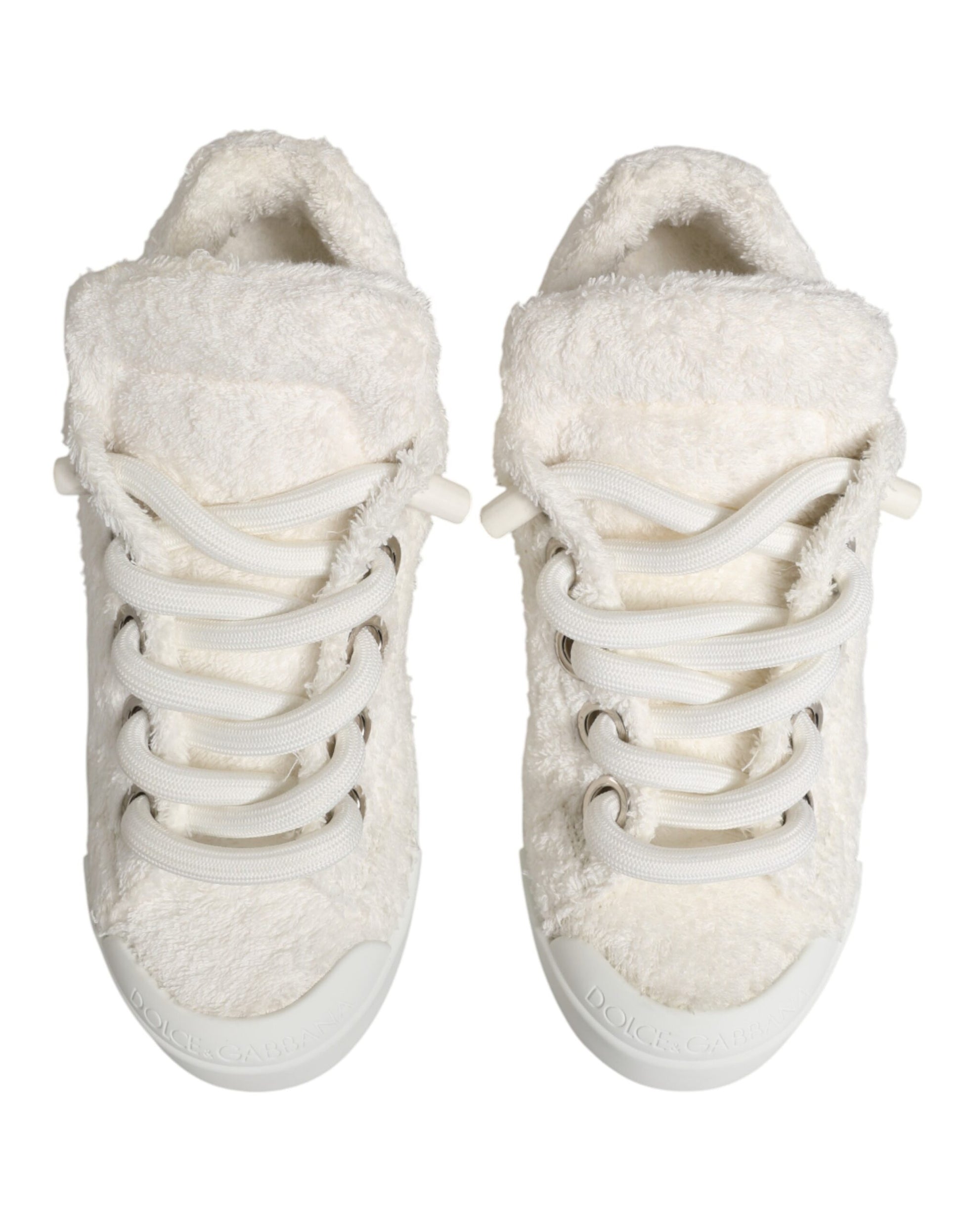 Pair of white faux shearling sneakers with laces and a low top