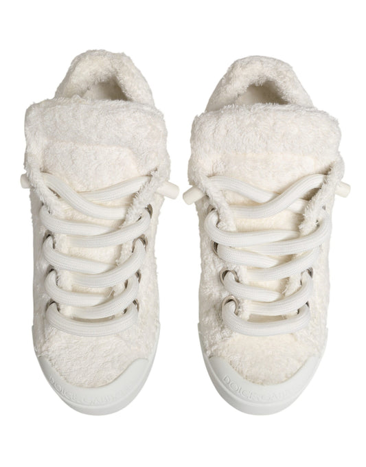 Pair of white faux shearling sneakers with laces and a low top