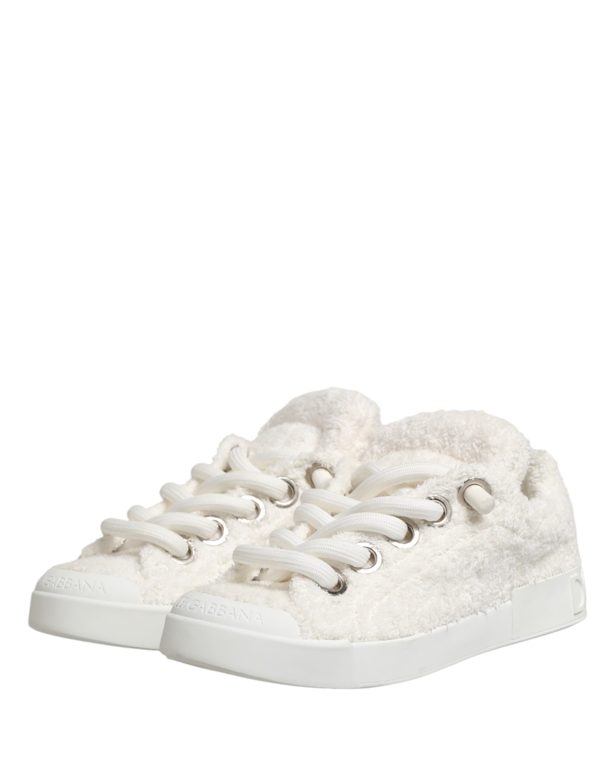A pair of white faux shearling low top sneakers with silver hardware