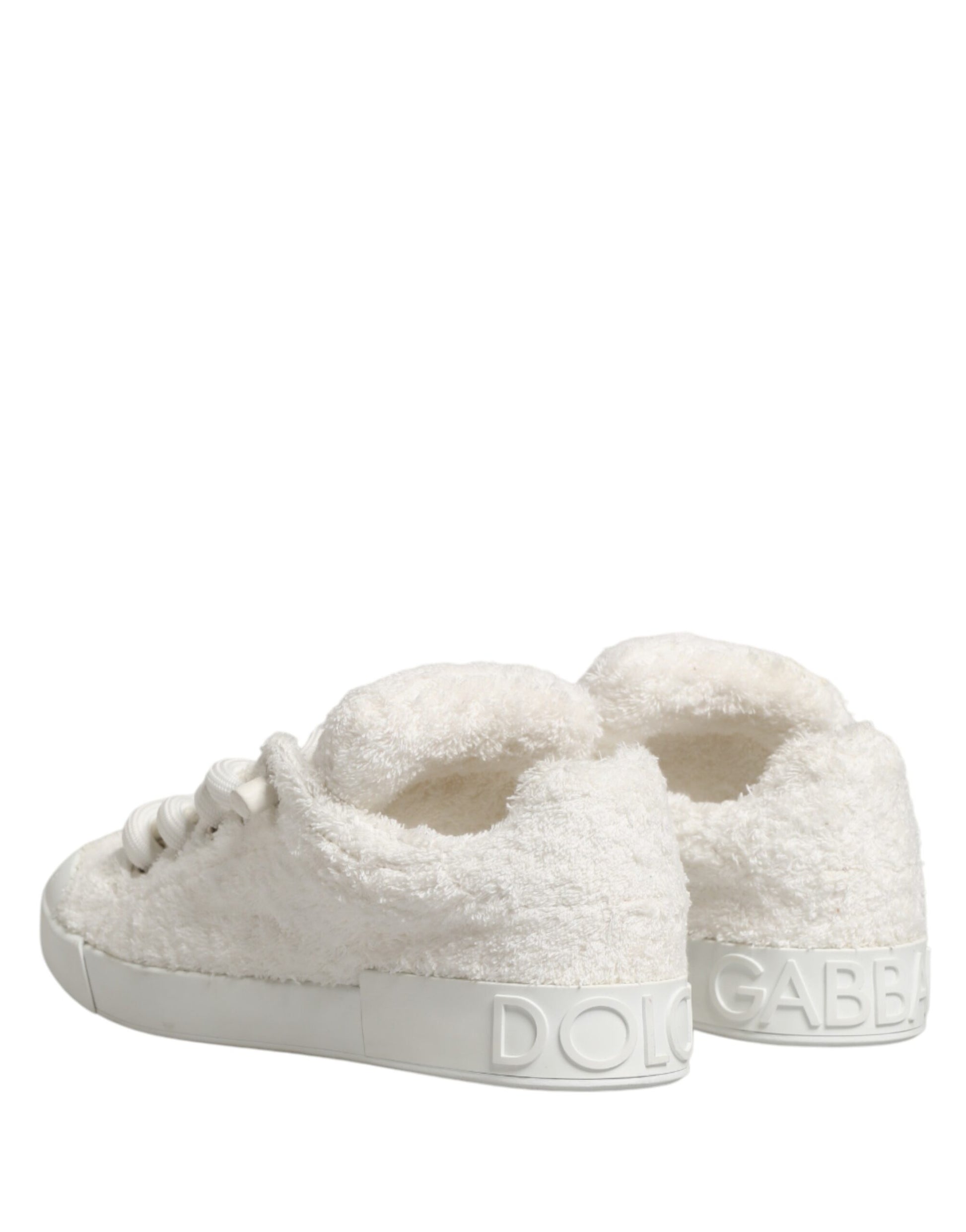 Pair of white faux shearling low top sneakers with brand name on side