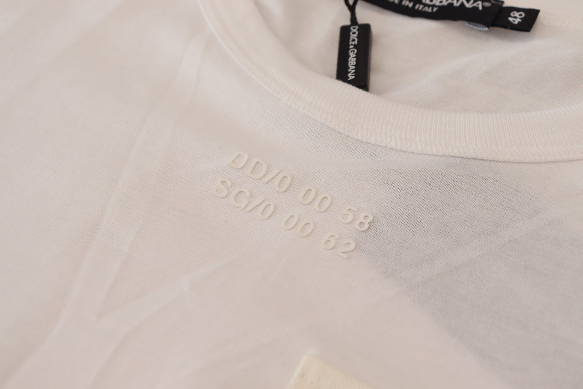 White t-shirt on hanger with black lettering