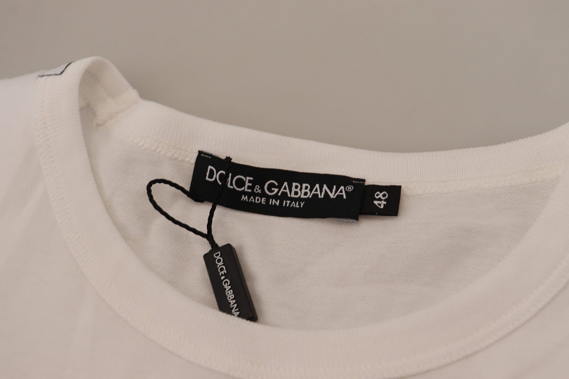 White t-shirt on hanger with black label