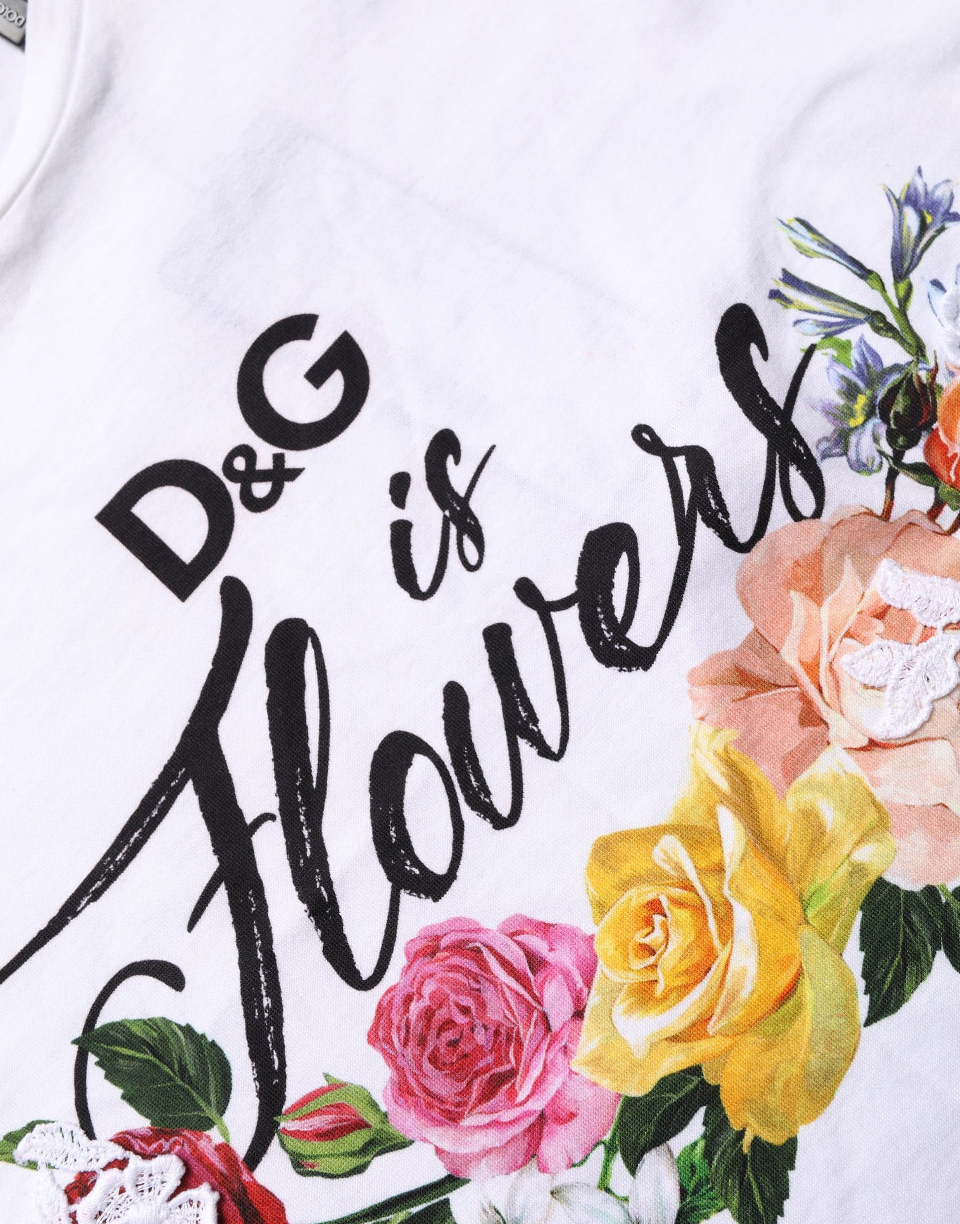A white t-shirt with a floral graphic and text