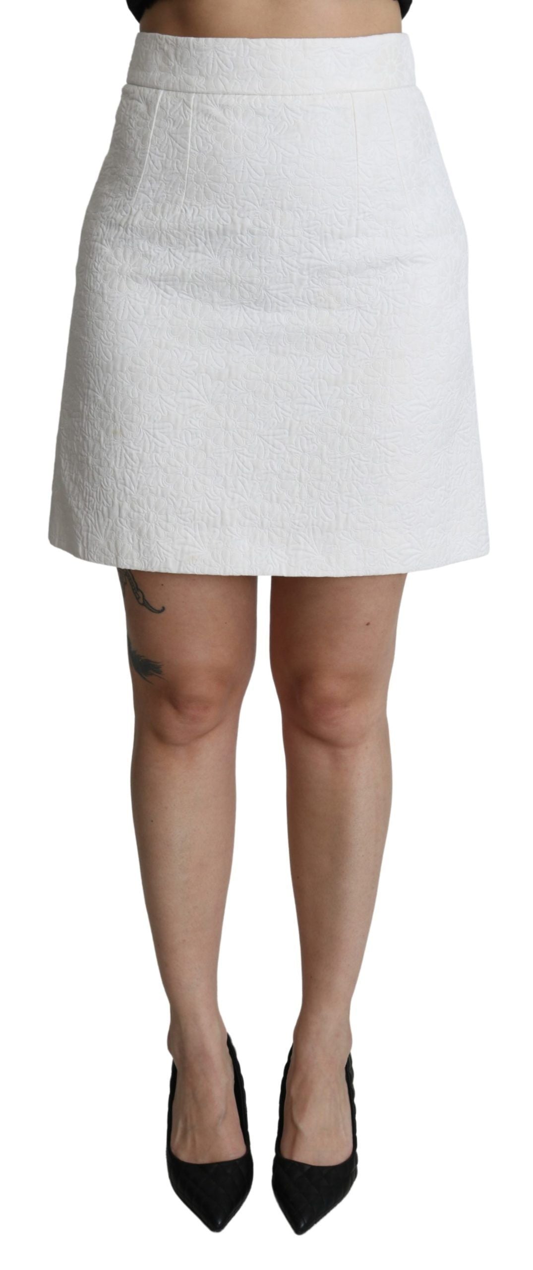White skirt with black waistband, worn by a person standing against a grey background