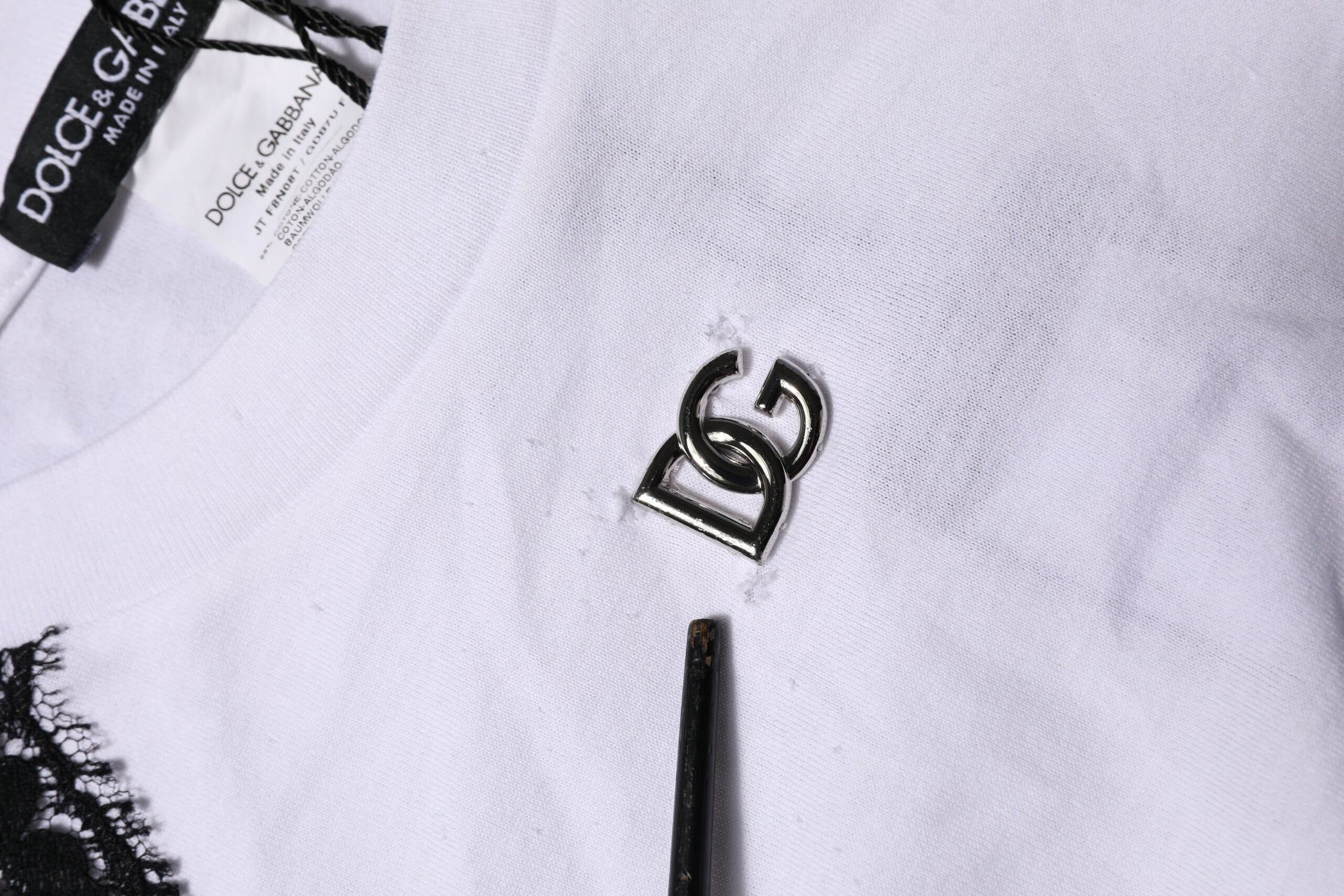 White t-shirt with a silver logo on front