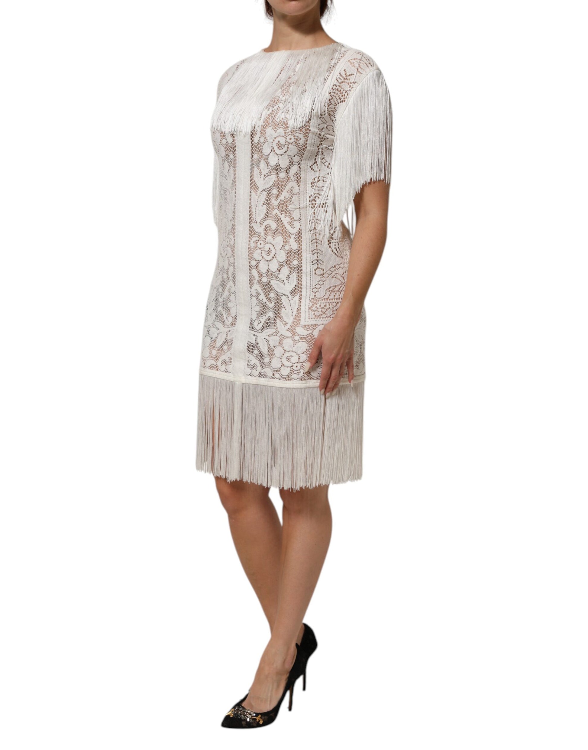 A white lace dress with fringe details and floral patterns, knee length
