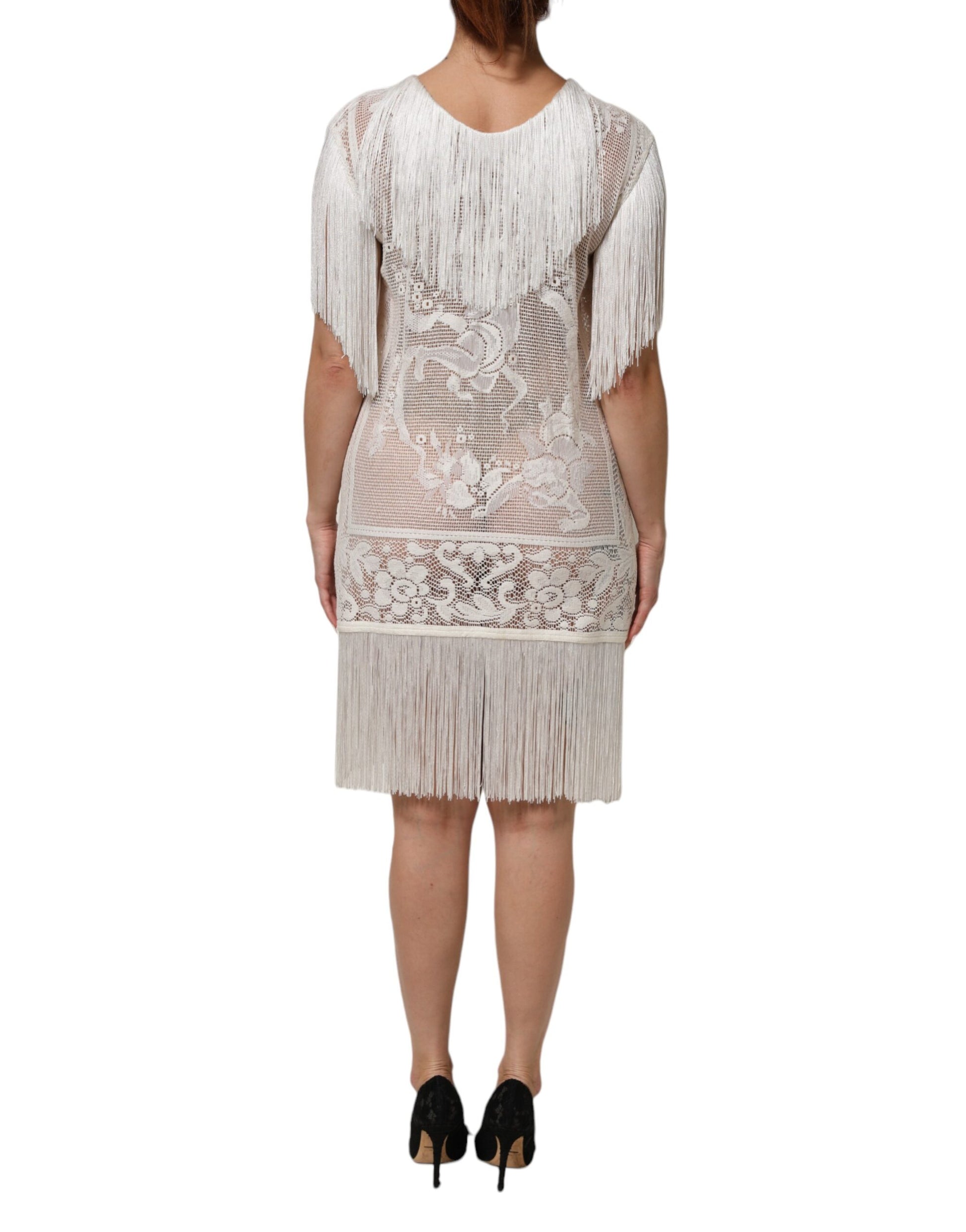 A white lace dress with fringe details and floral pattern, knee length