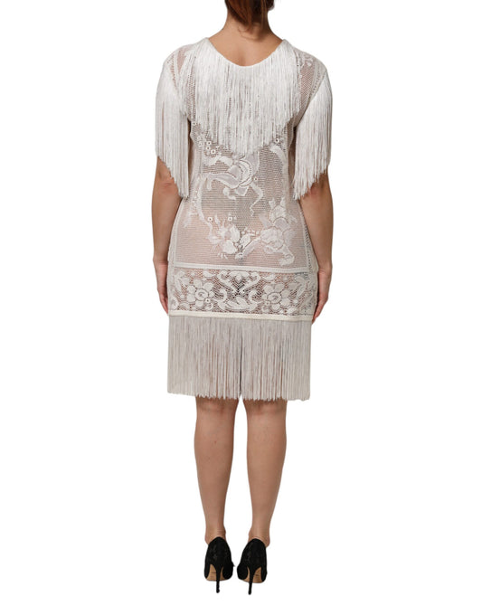 A white lace dress with fringe details and floral pattern, knee length