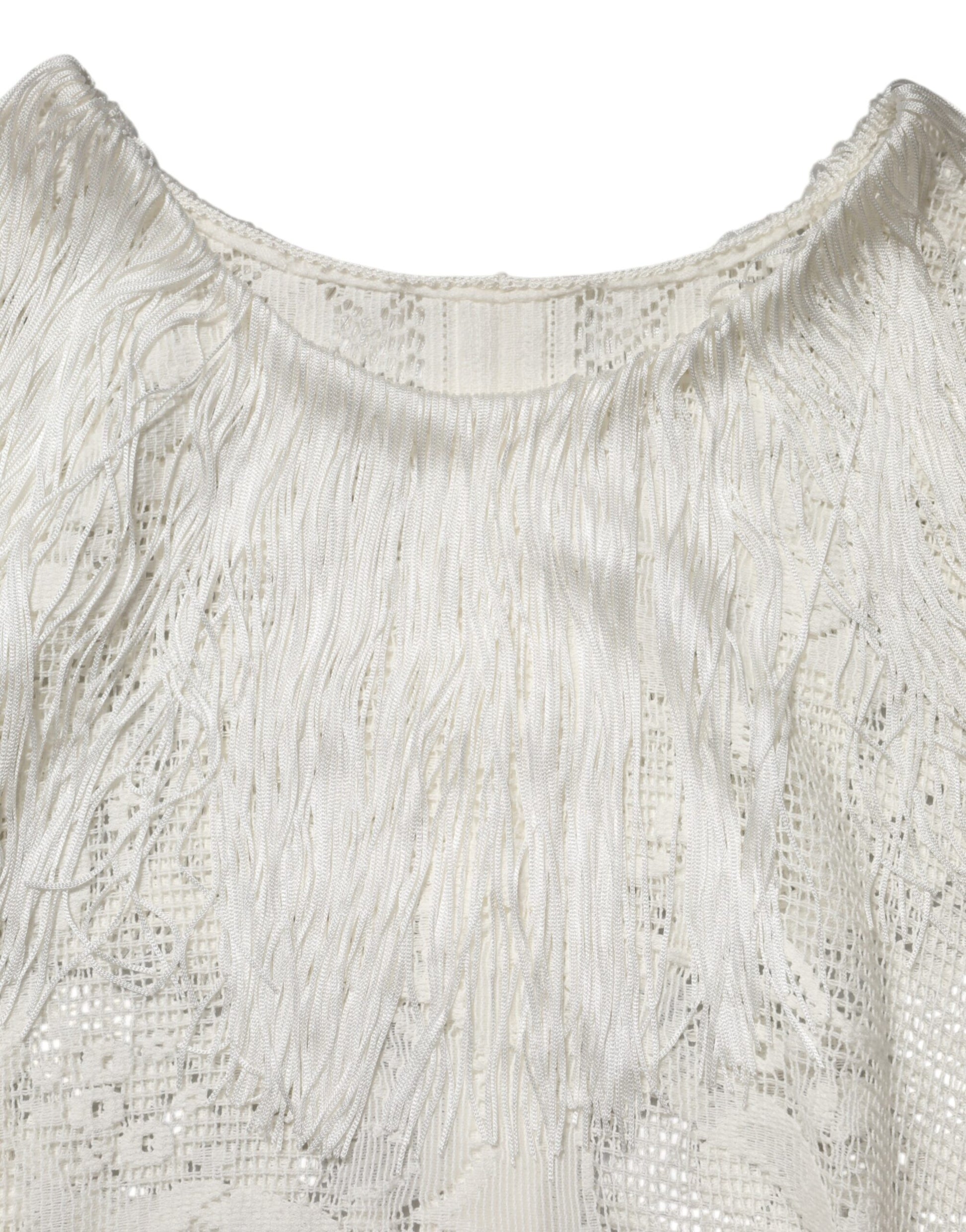 A white lace dress with floral patterns and fringe details on the sleeves