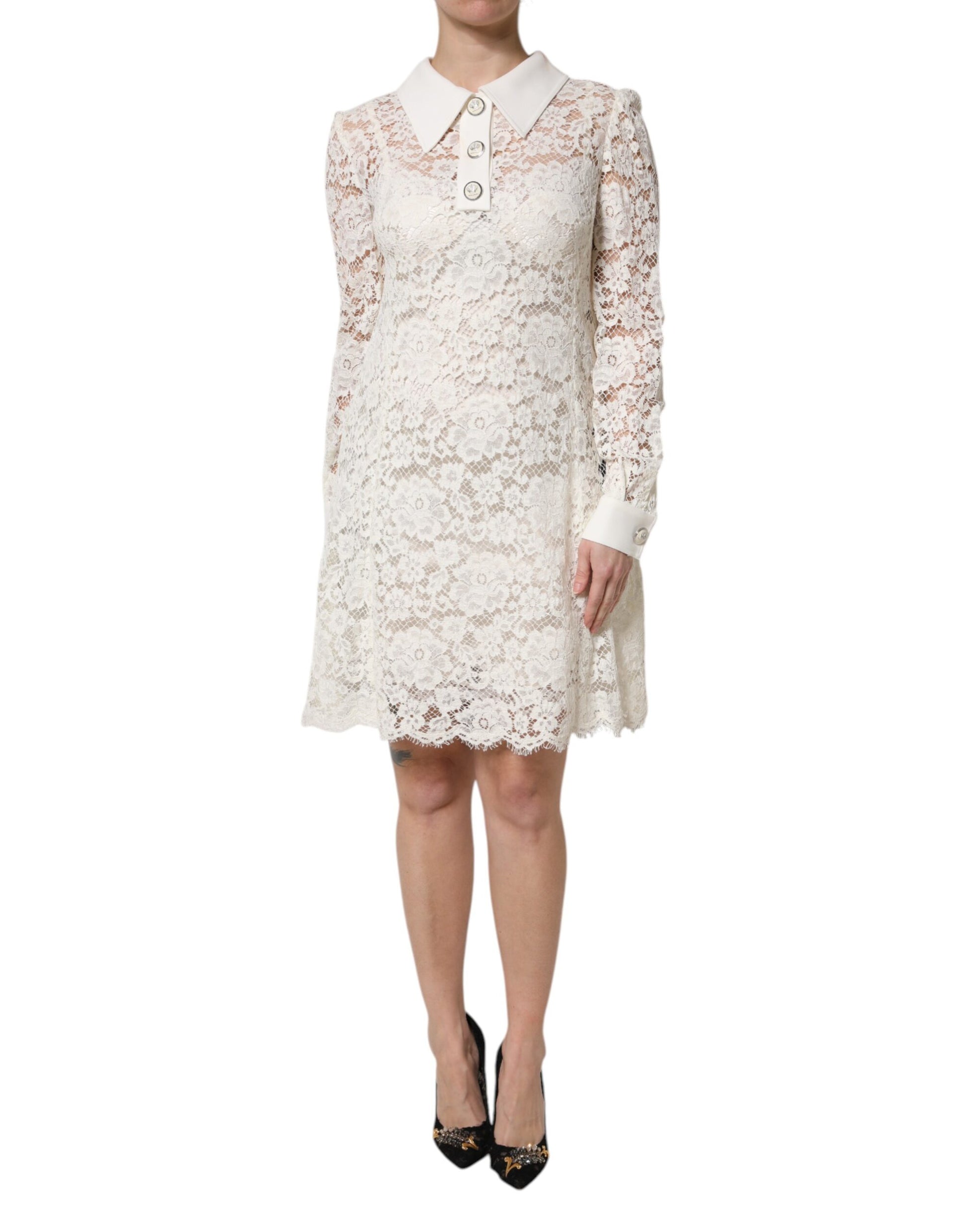 A white lace dress with long sleeves and a floral pattern, designed by Dolce & Gabbana