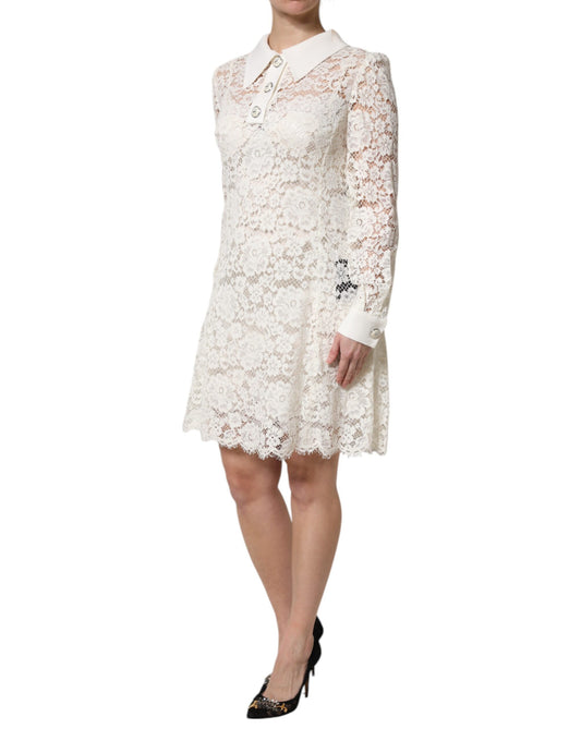 A white lace dress with long sleeves and a floral pattern, designed by Dolce & Gabbana