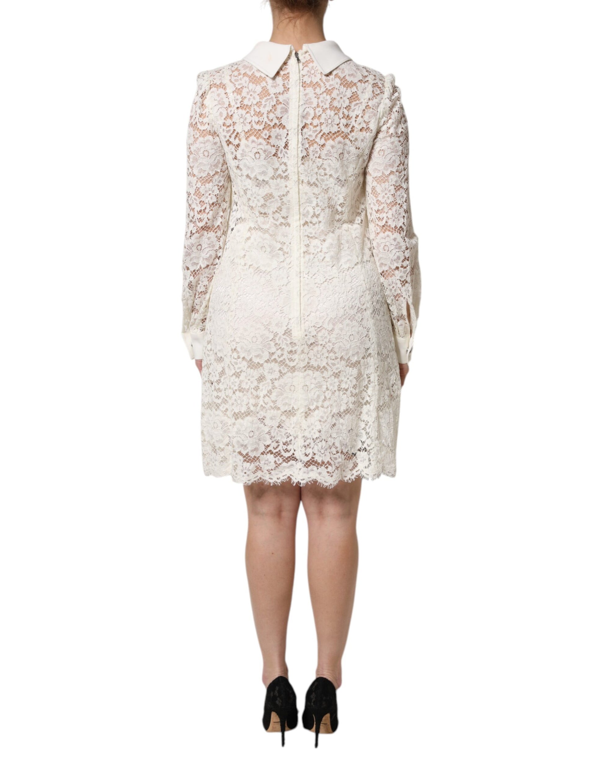A white lace dress with long sleeves and a shift silhouette, designed by Dolce & Gabbana