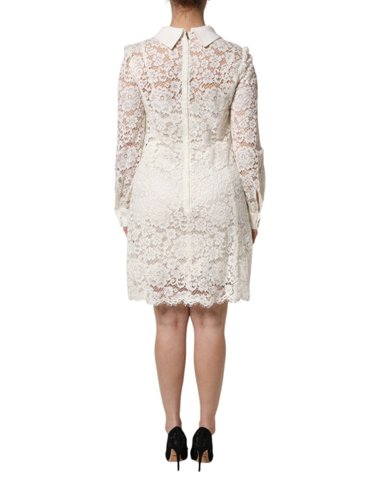 A white lace dress with long sleeves and a shift silhouette, designed by Dolce & Gabbana