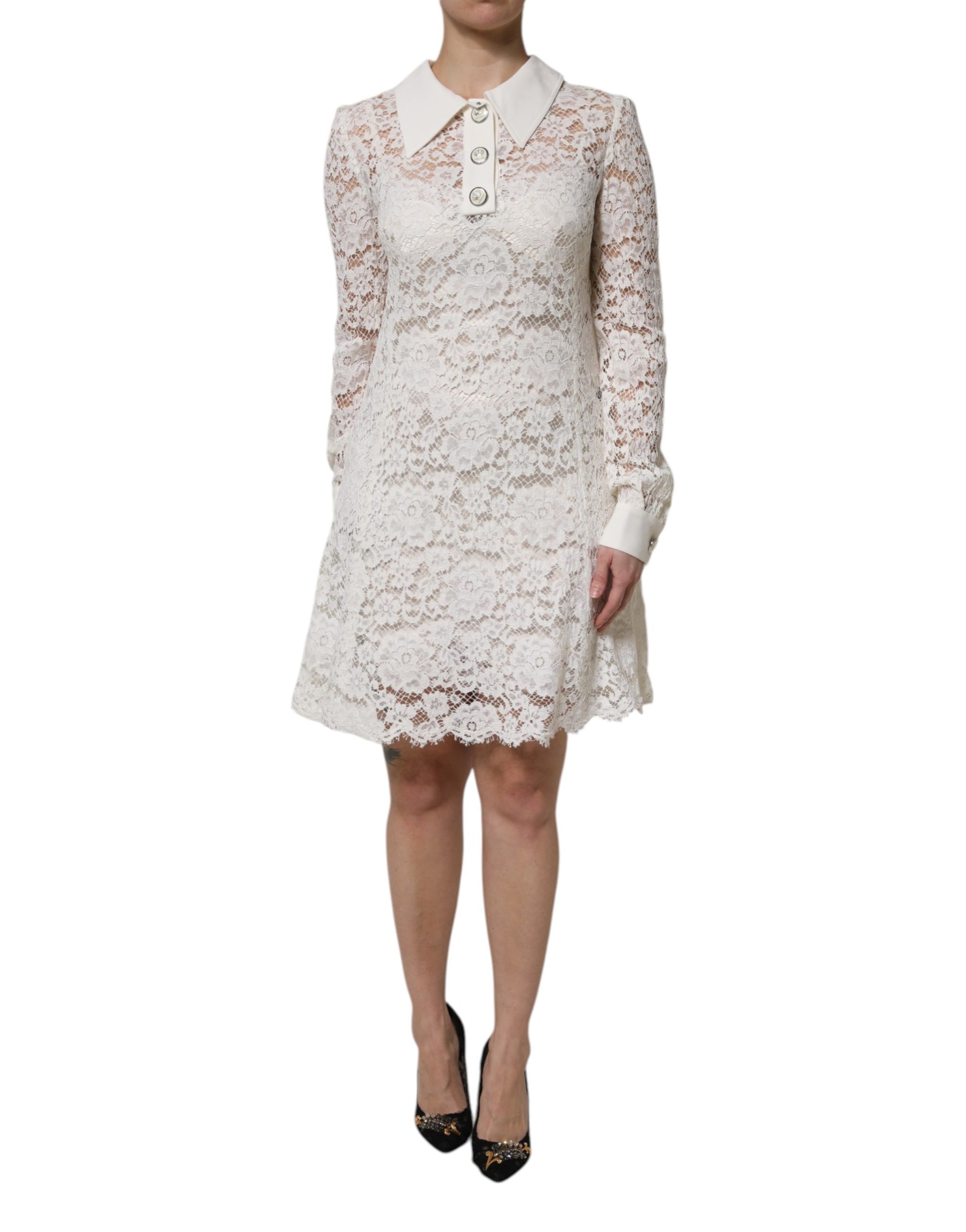 A white lace dress with a collar and short sleeves, featuring floral patterns