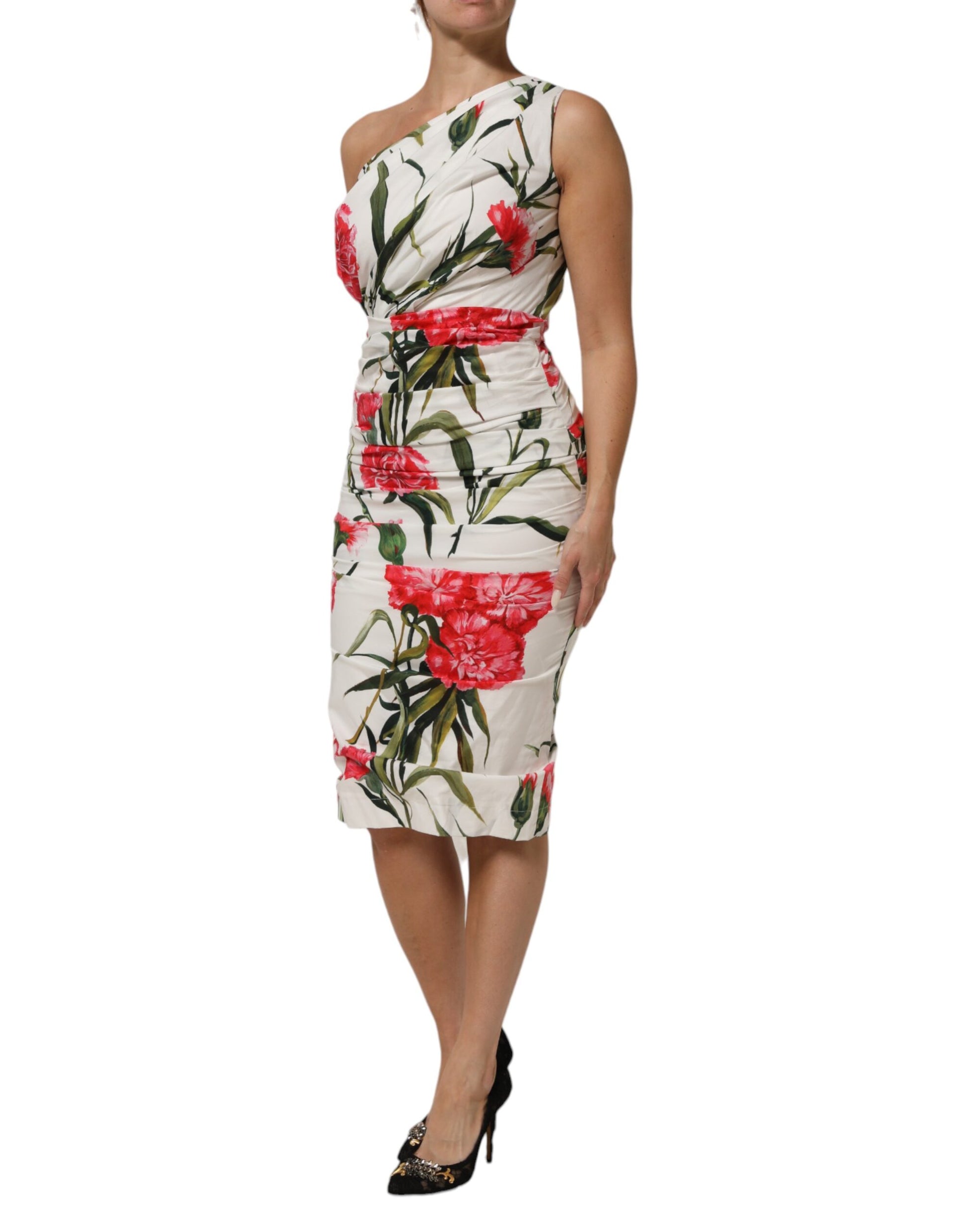 A woman wearing a white floral one shoulder sheath dress by Dolce & Gabbana