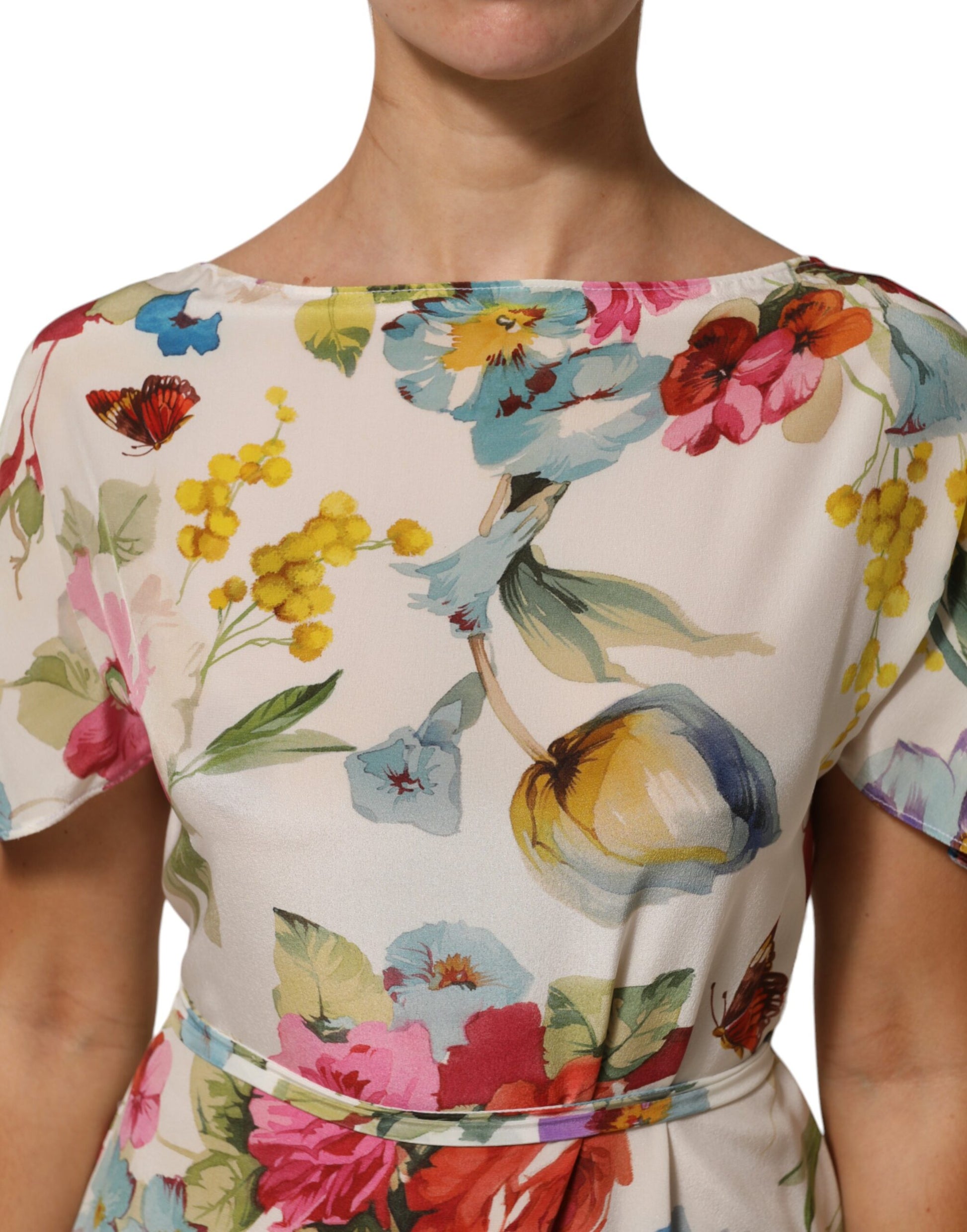 A woman wearing a floral print dress with a V-neckline and short sleeves