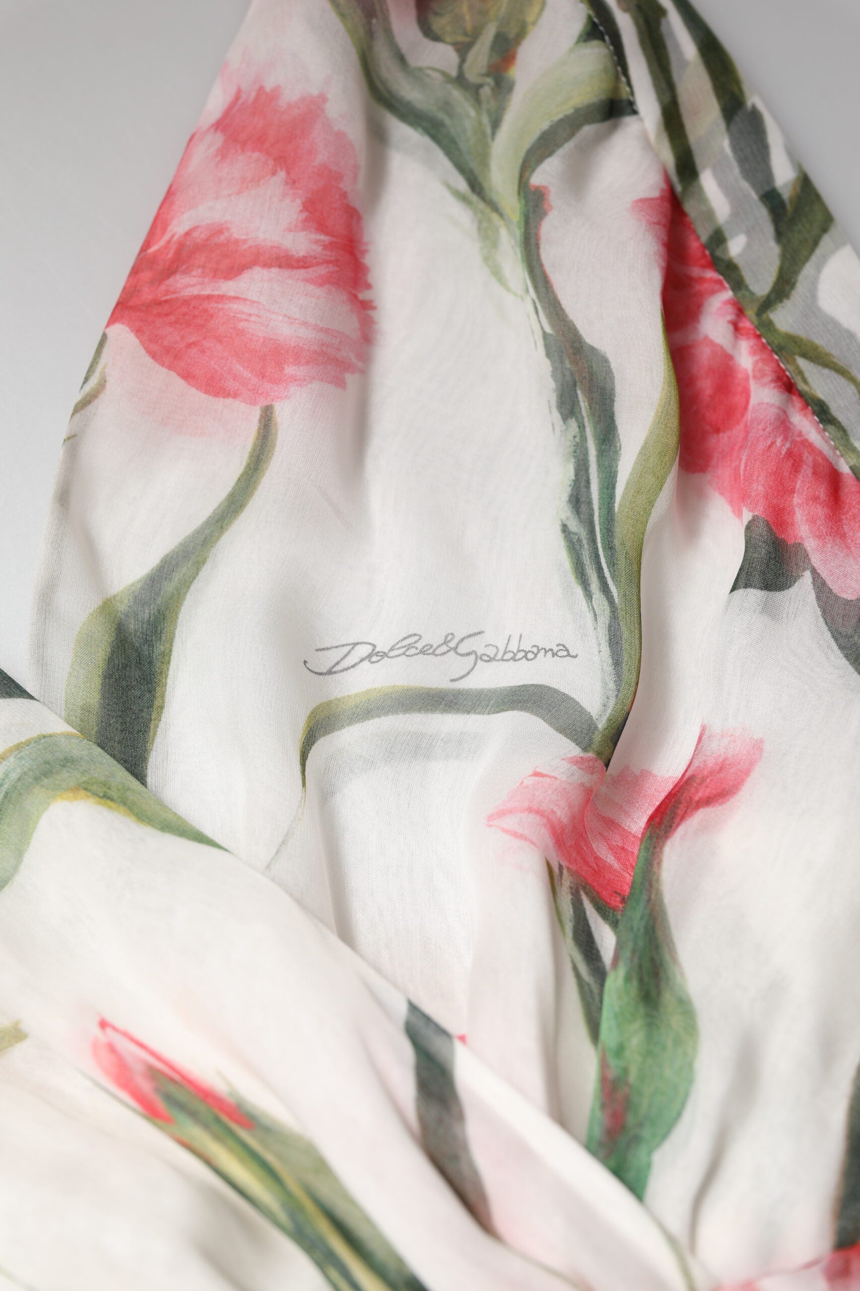 A white floral silk scarf with a halter neck and long sleeves