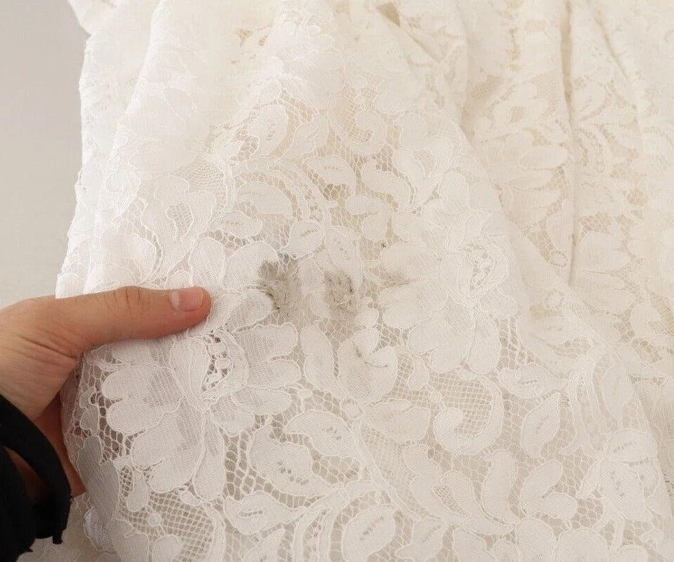 A white lace dress with floral embroidery