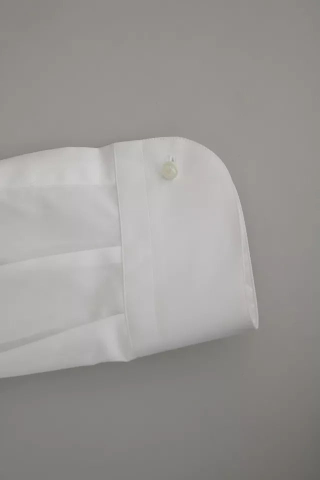 A white tuxedo dress with a gold shirt and black pants, designed by Dolce & Gabbana