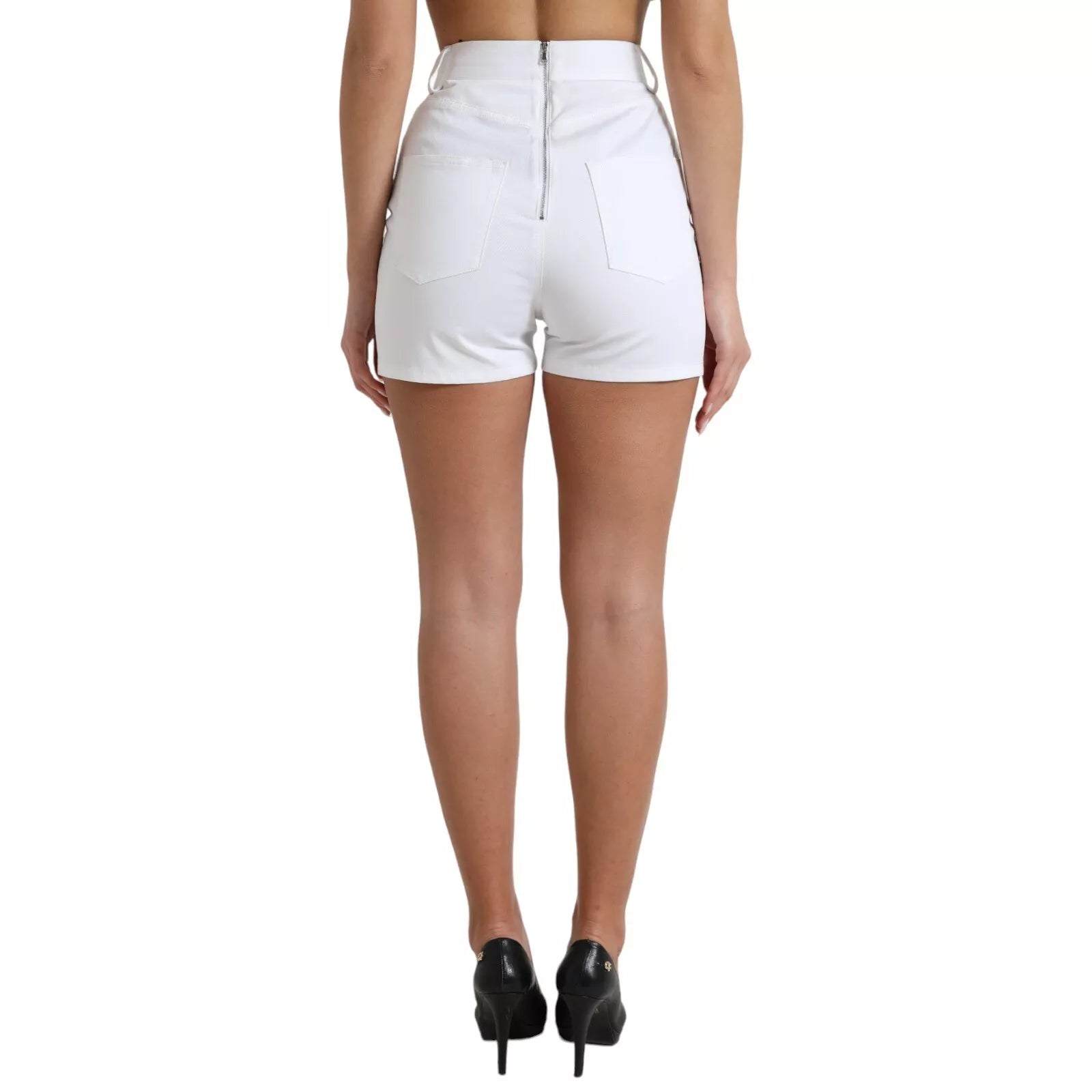 Woman wearing white shorts and black heels