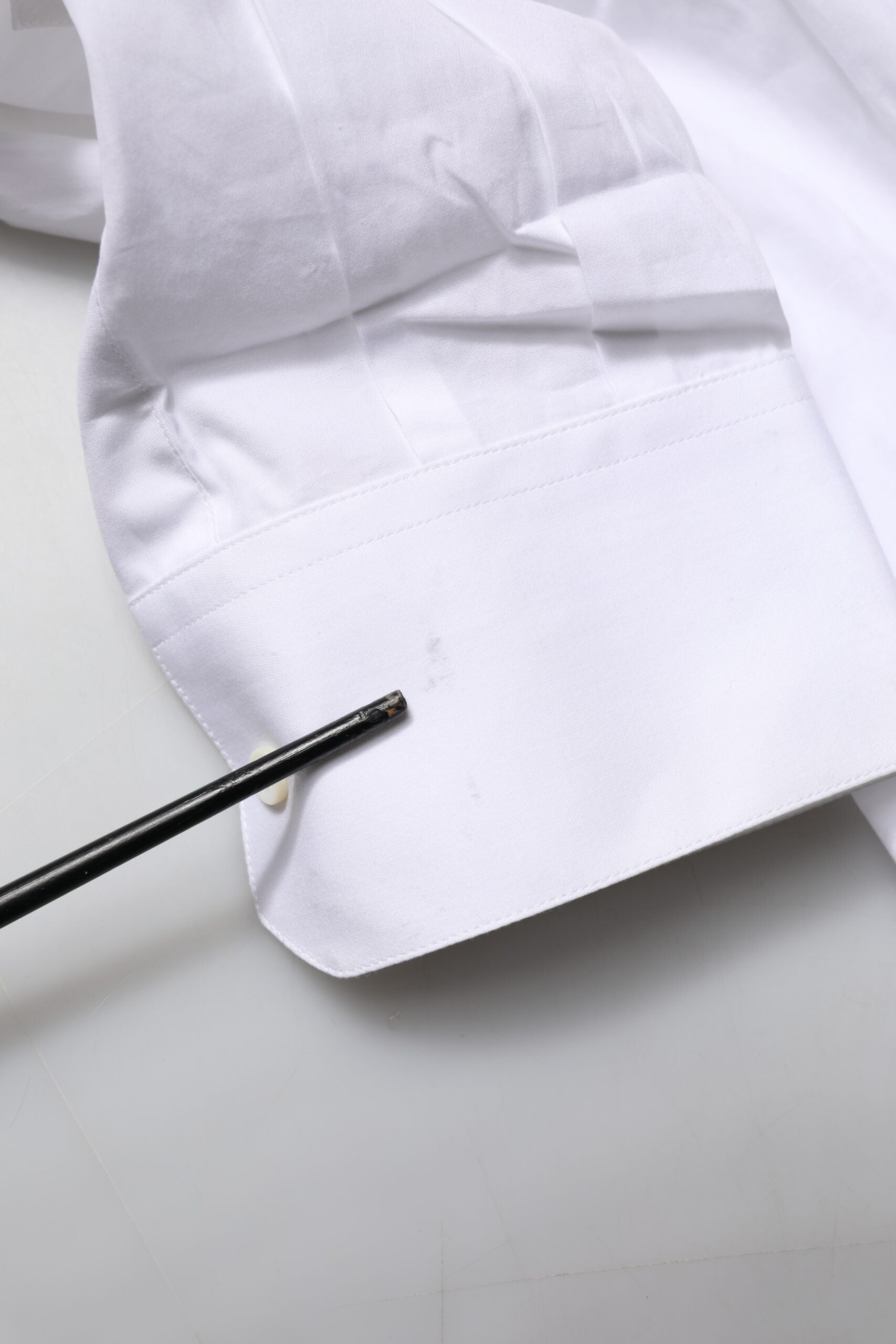 A white dress shirt with a gold bib and collar, designed by Dolce & Gabbana