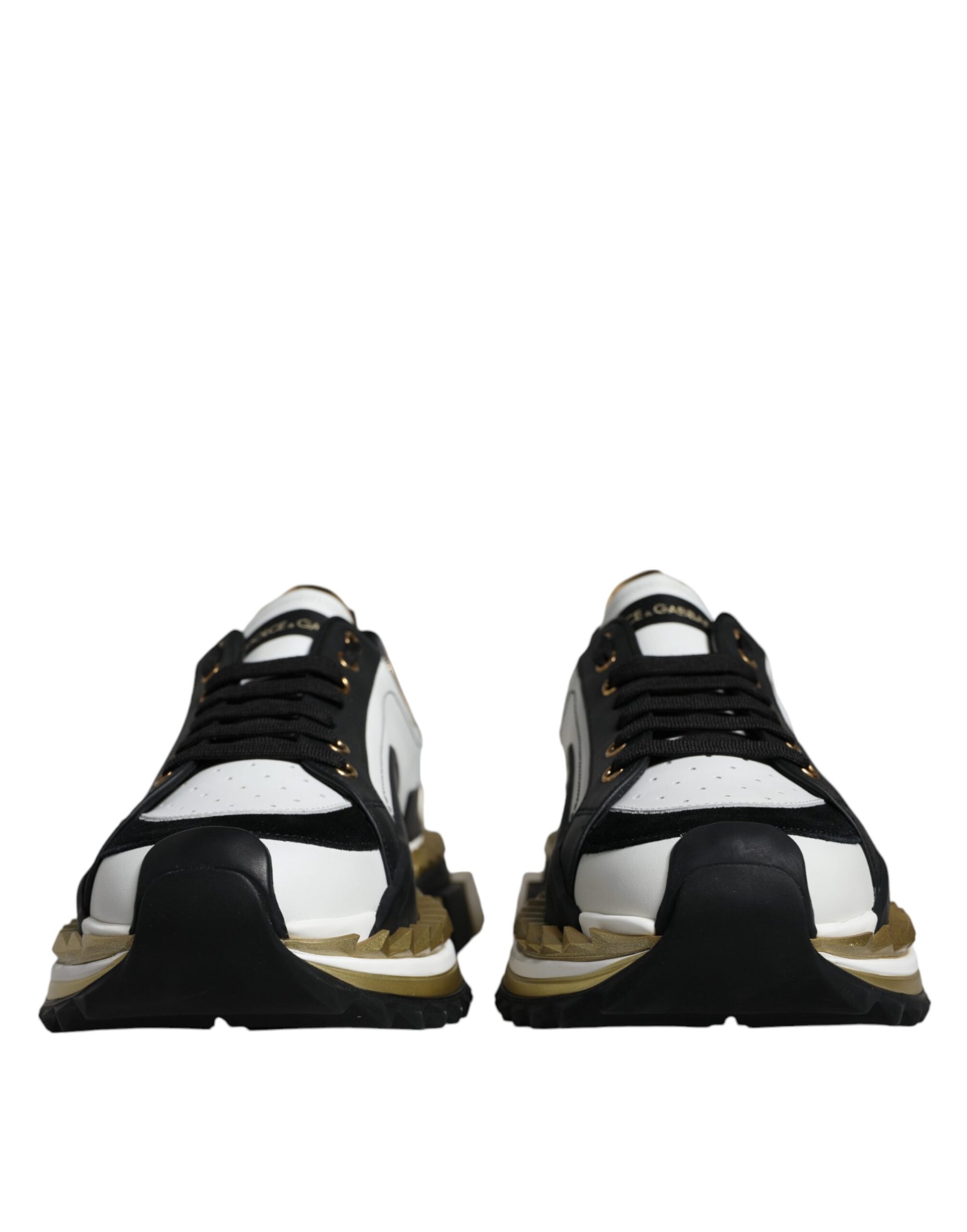 Pair of black and white sneakers with gold accents