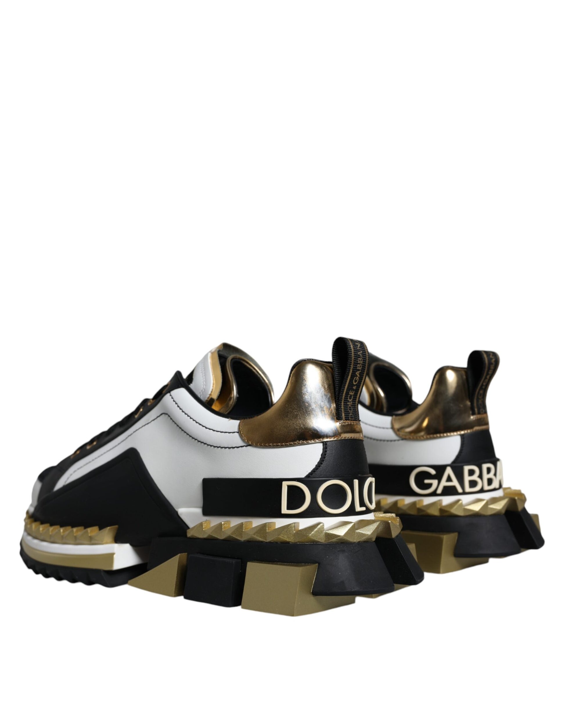 Pair of high top sneakers with gold accents and black laces