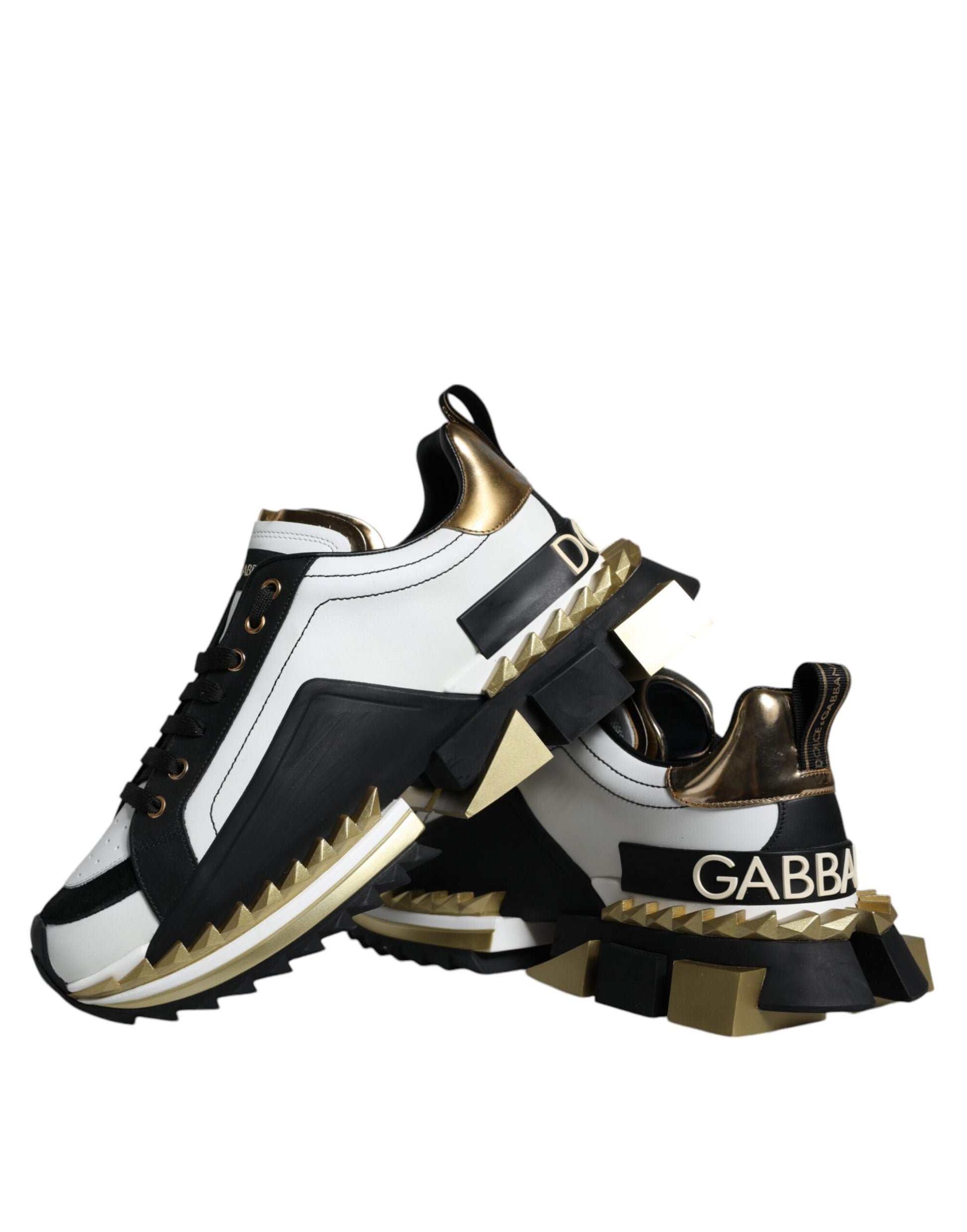 Pair of white and black sneakers with gold accents