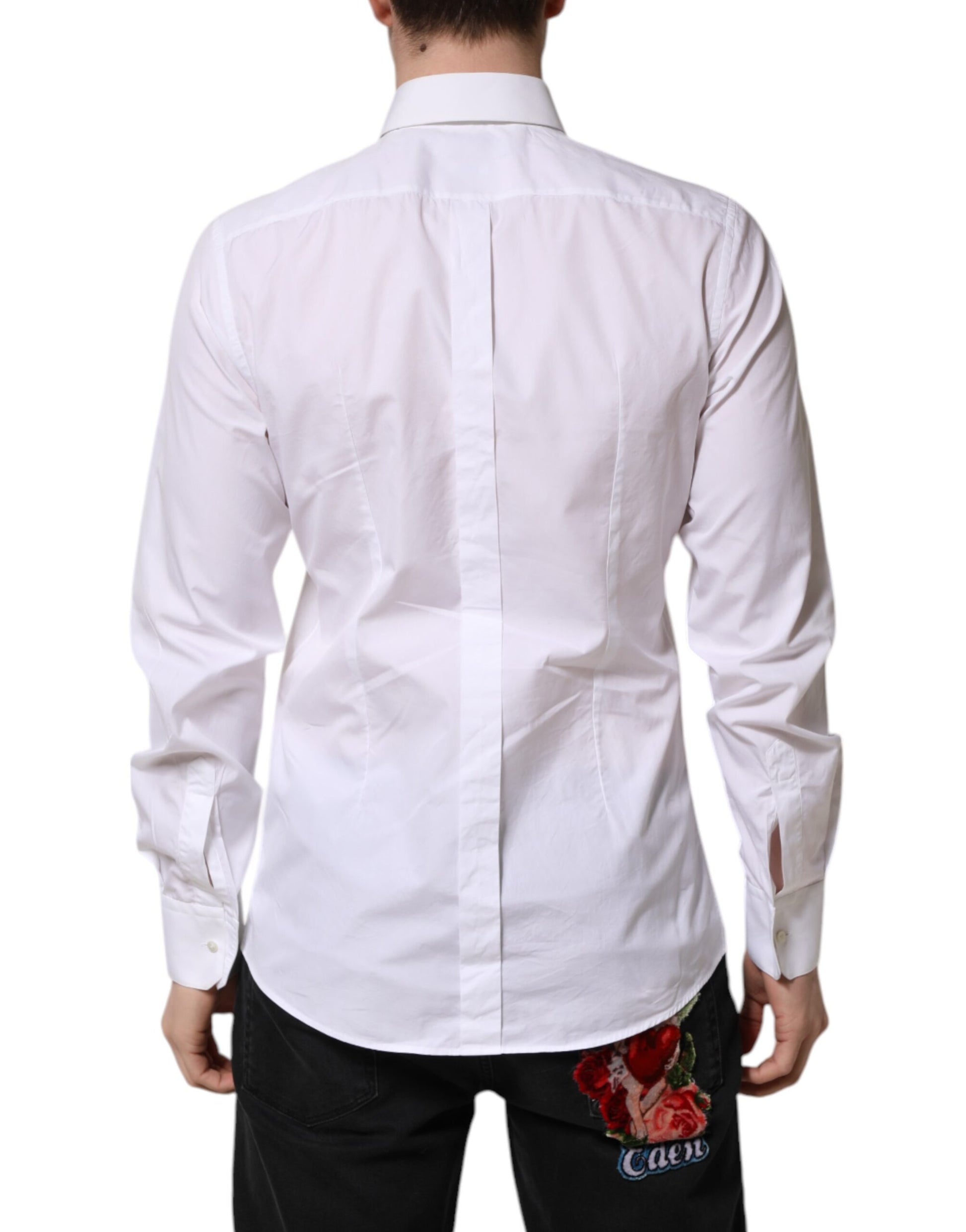 A white cotton shirt with gold accents, designed by Dolce & Gabbana. It features a bib front and is part of t