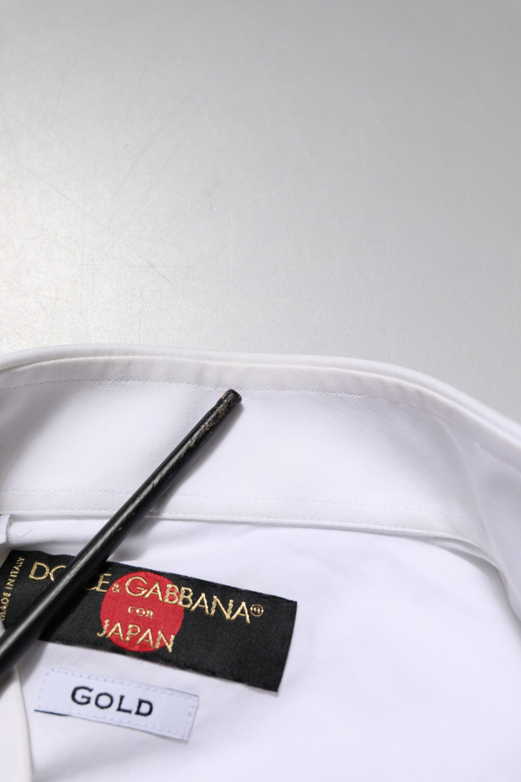 A white cotton bib dress shirt with a gold and red label from Dolce & Gabbana Japan