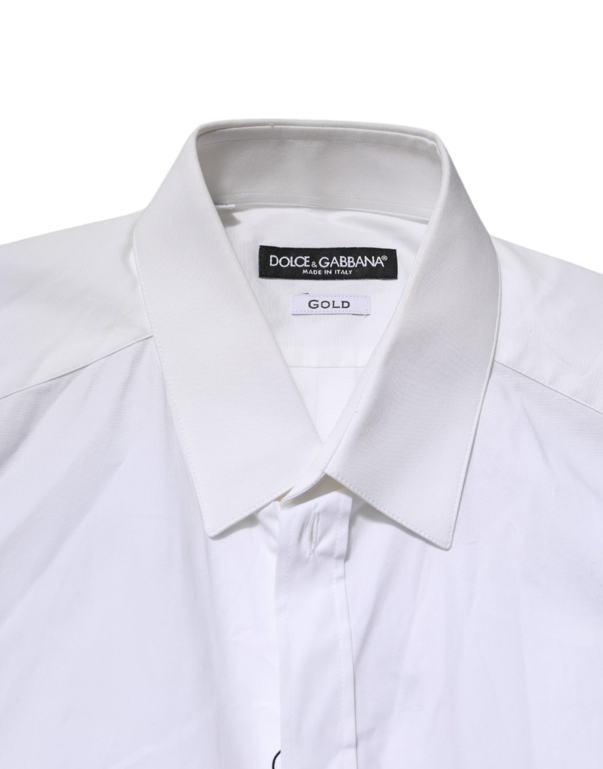 A white collared dress shirt with a gold label from Dolce & Gabbana
